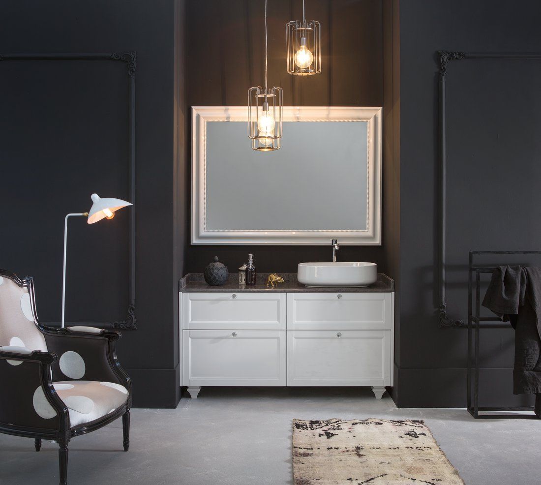 Un bagno con pareti nere e mobili bianchi