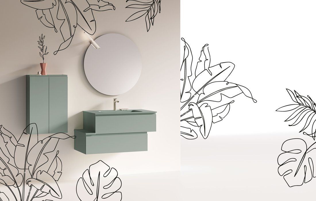 Un bagno con un lavandino, uno specchio e un disegno di foglie sul muro