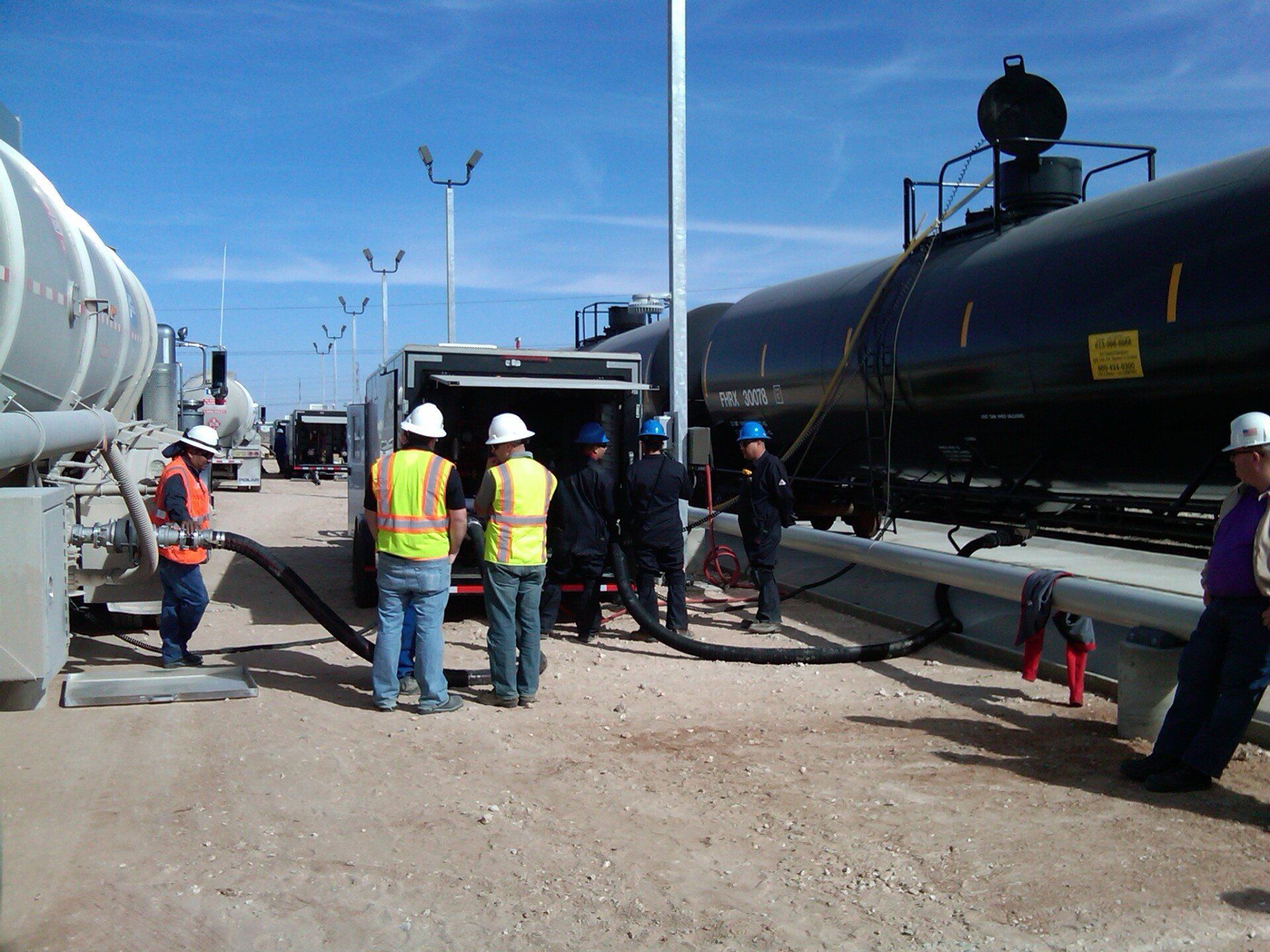 A group of men are standing in front of a train with the number 1 on it