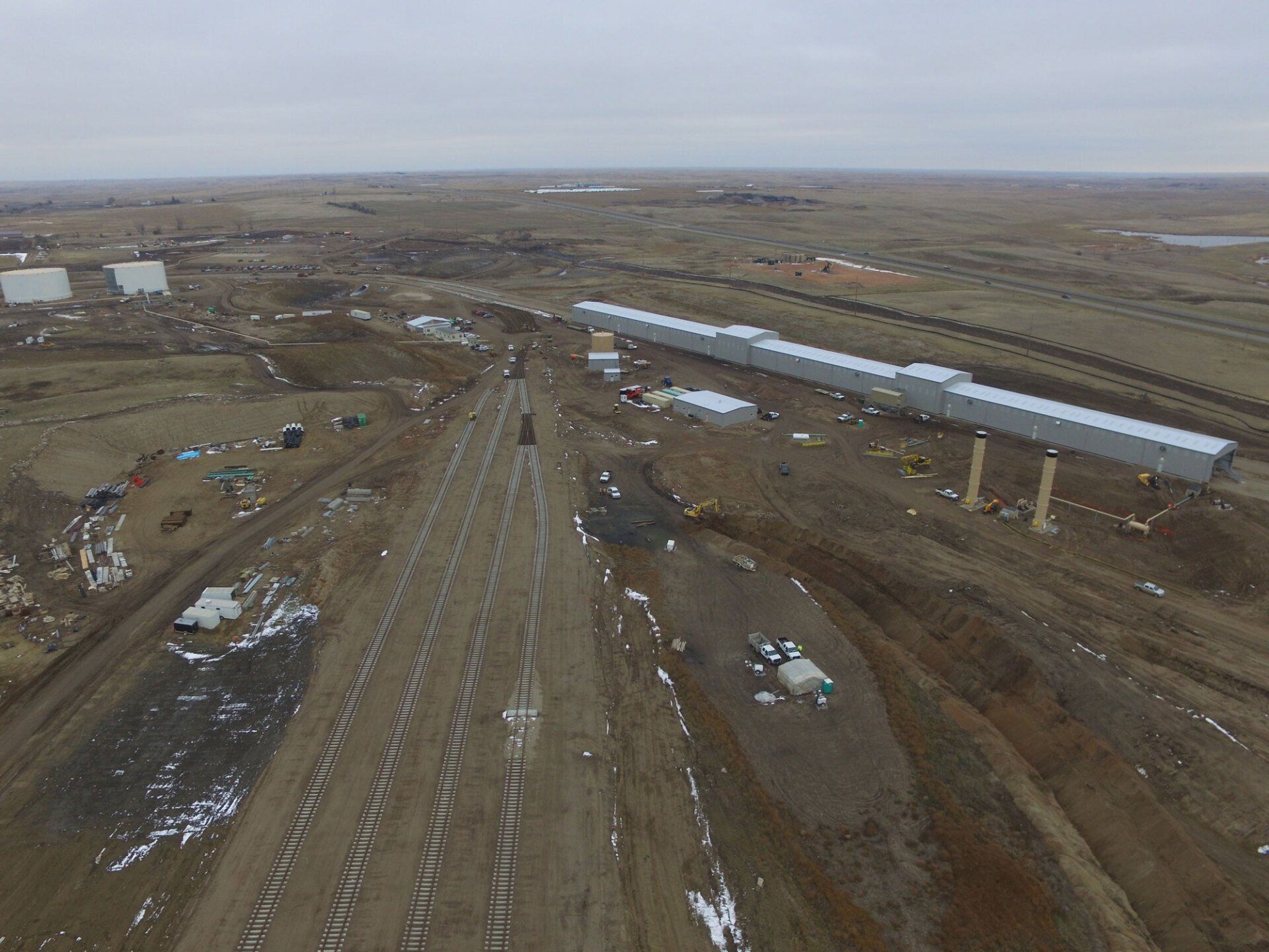 An aerial view of a train track in the middle of a field.