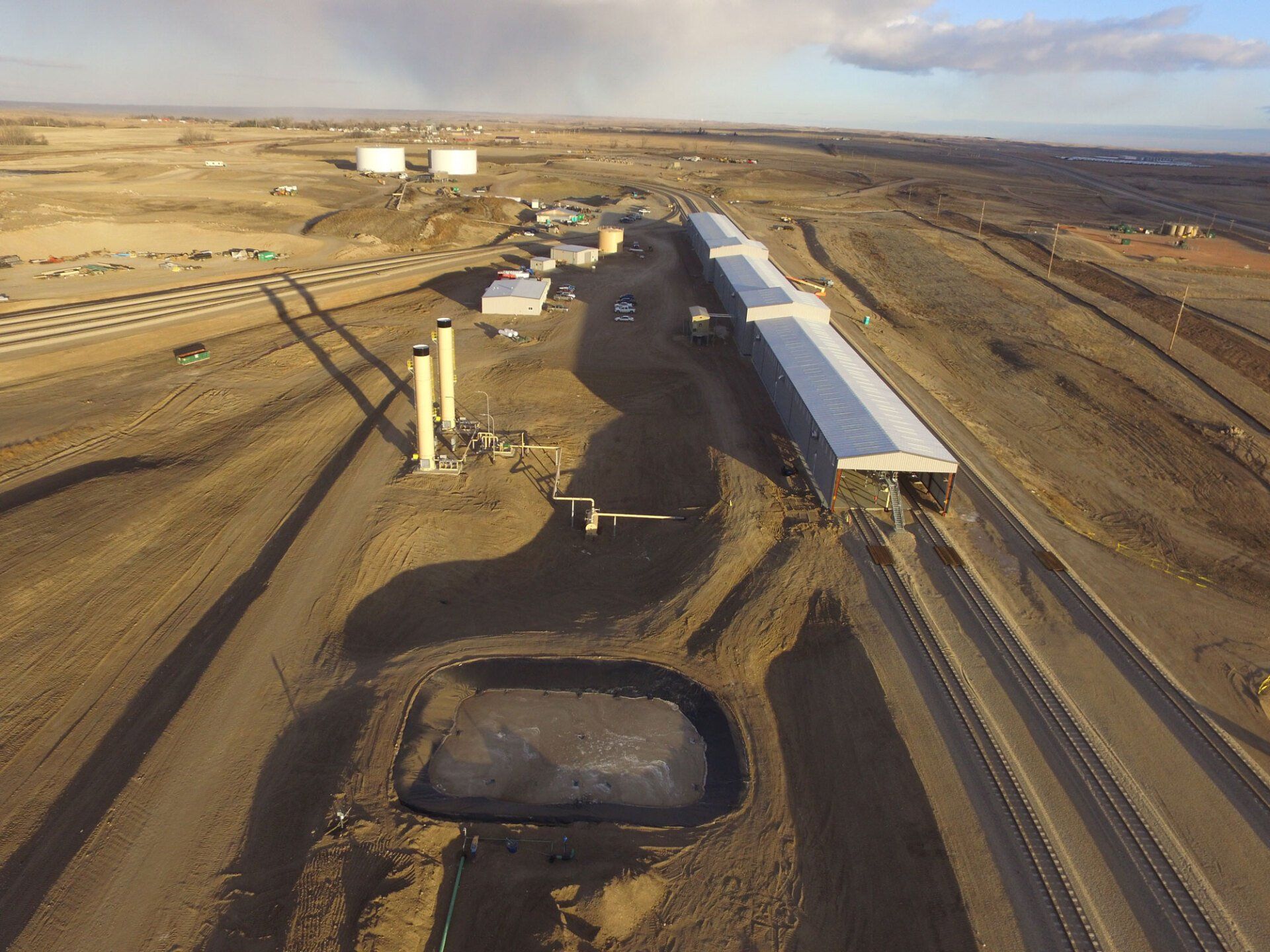 An aerial view of a train station in the middle of a desert.