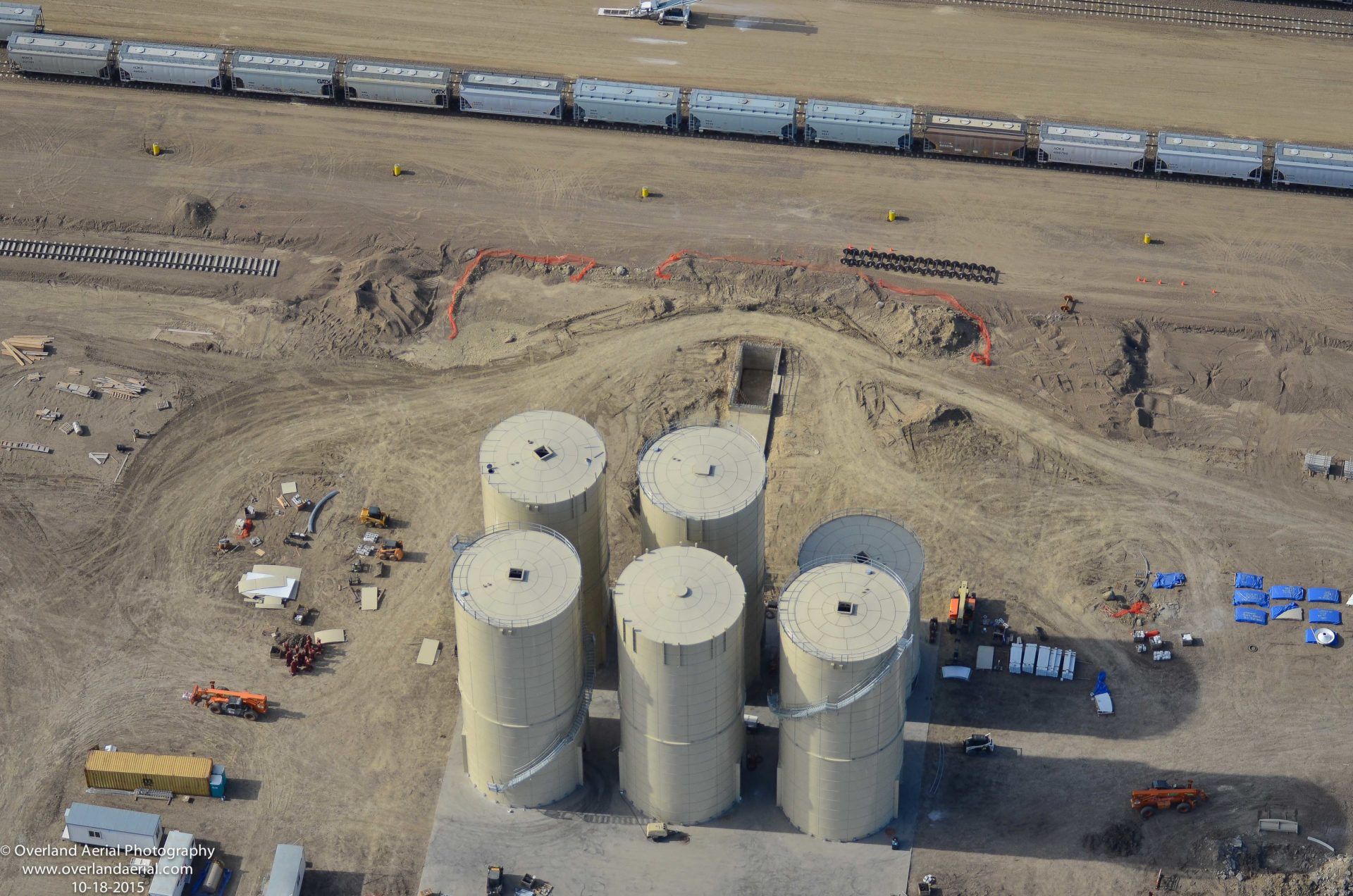 An aerial view of a construction site with a train going by