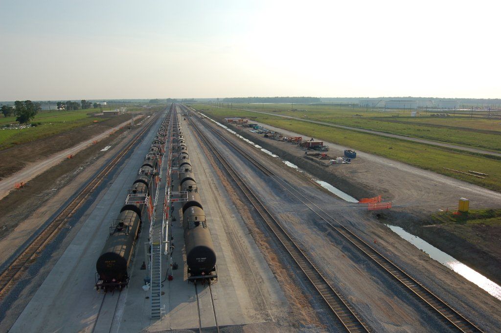 An aerial view of a train yard with a lot of train cars on the tracks.