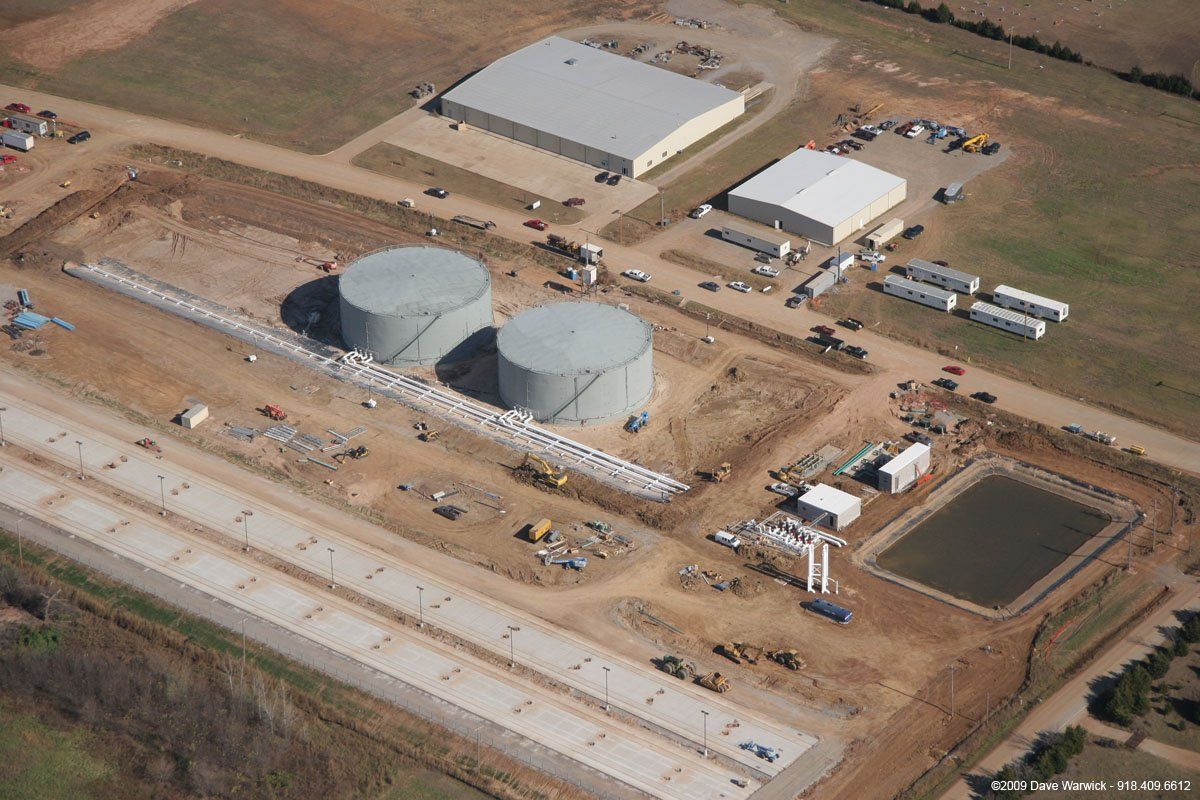 An aerial view of a construction site with tanks and buildings