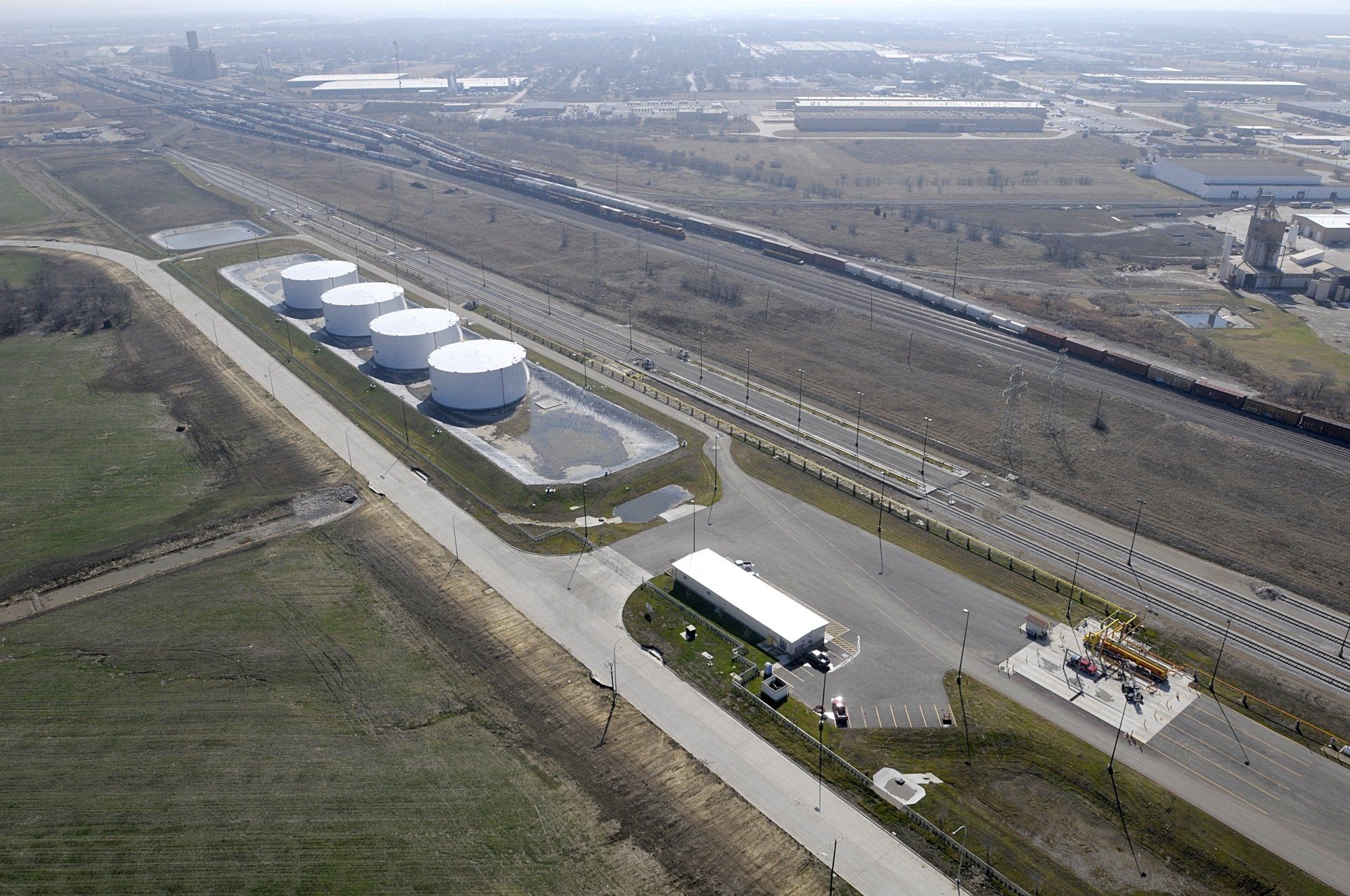 An aerial view of a large industrial area with lots of tanks