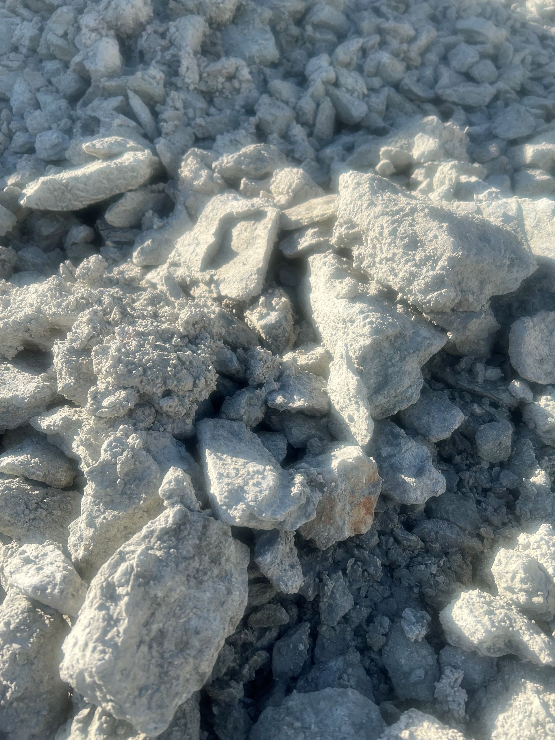 A pile of white gravel is sitting on the ground.