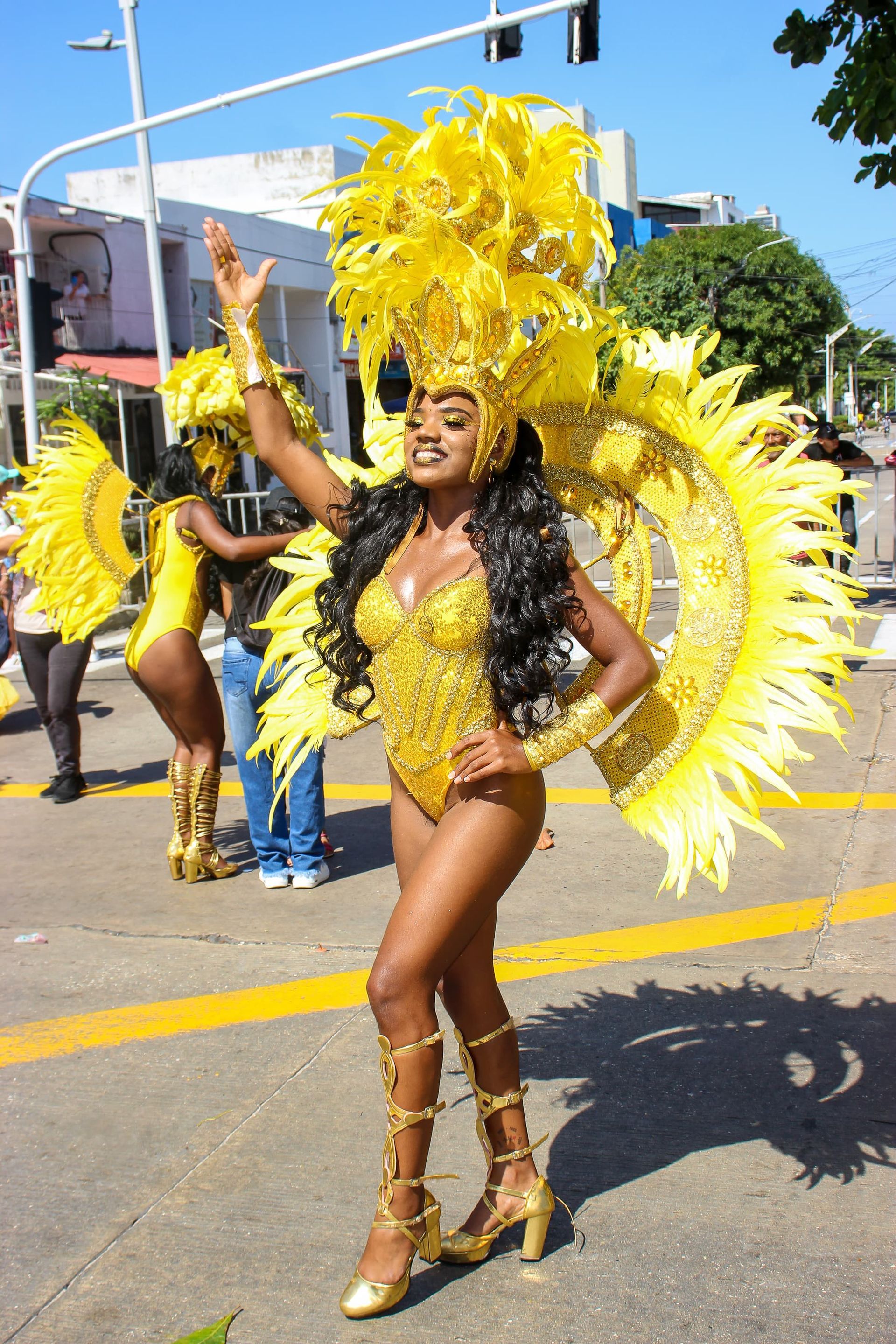 Una mujer con un disfraz de carnaval está parada en la calle.