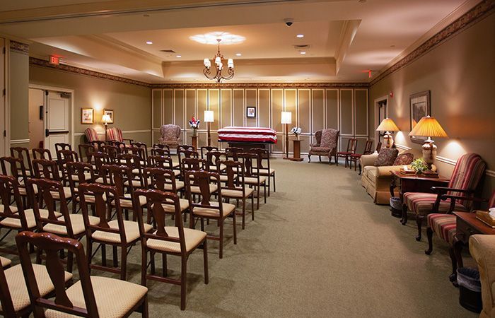 A conference room with a table and chairs and a flat screen tv