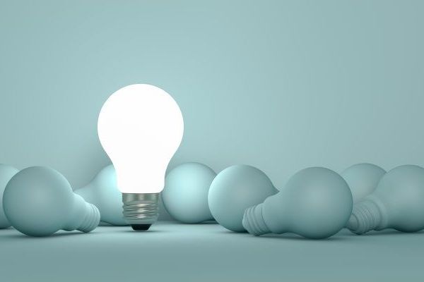 a man in a suit and tie and a woman in a blue shirt are posing for a picture .