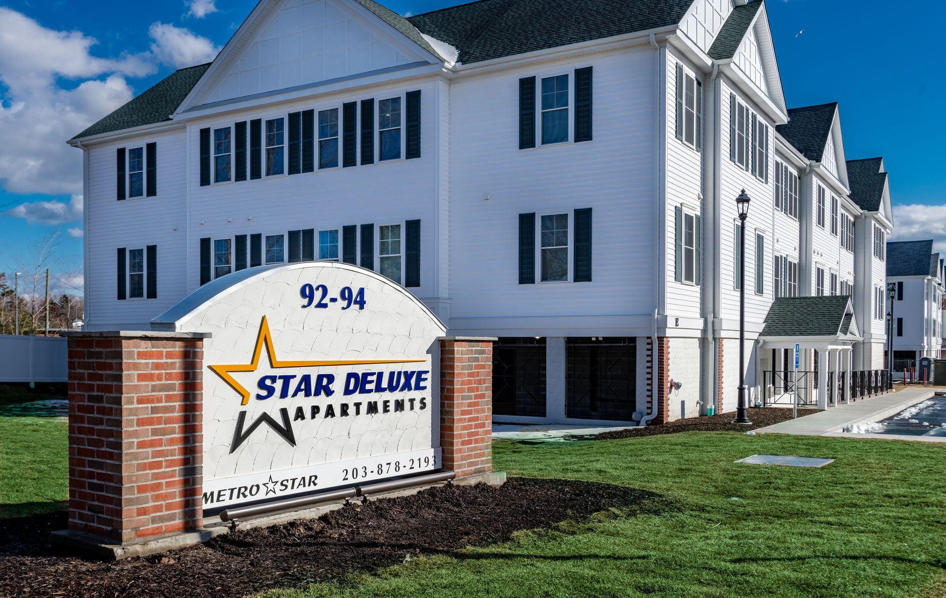A star deluxe apartment building with a sign in front of it