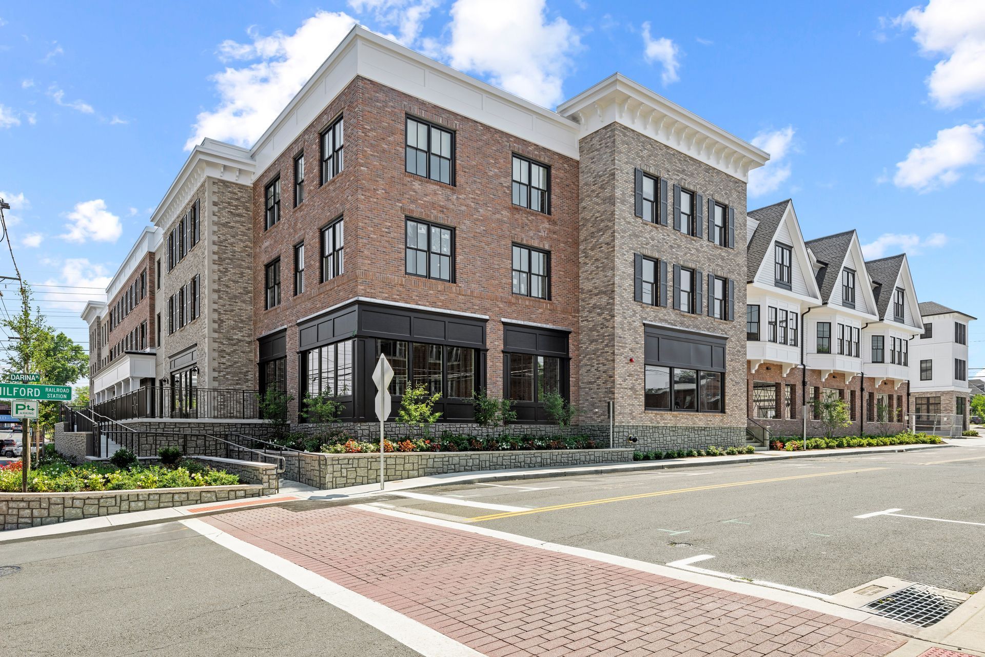 An artist 's impression of a large brick building with a lot of windows.