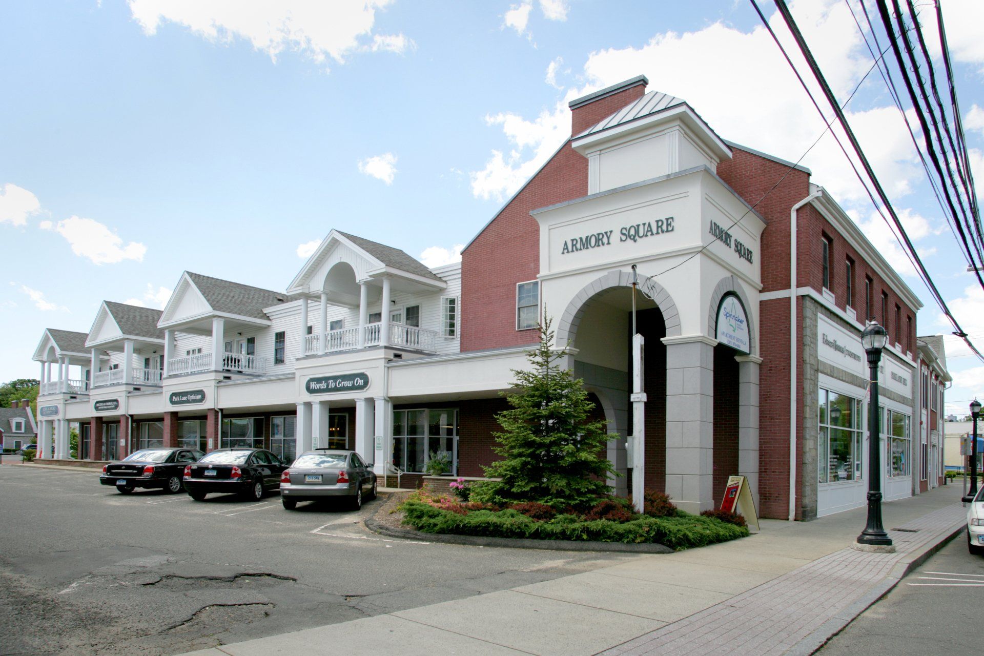 Cars are parked in front of a building that says journey square