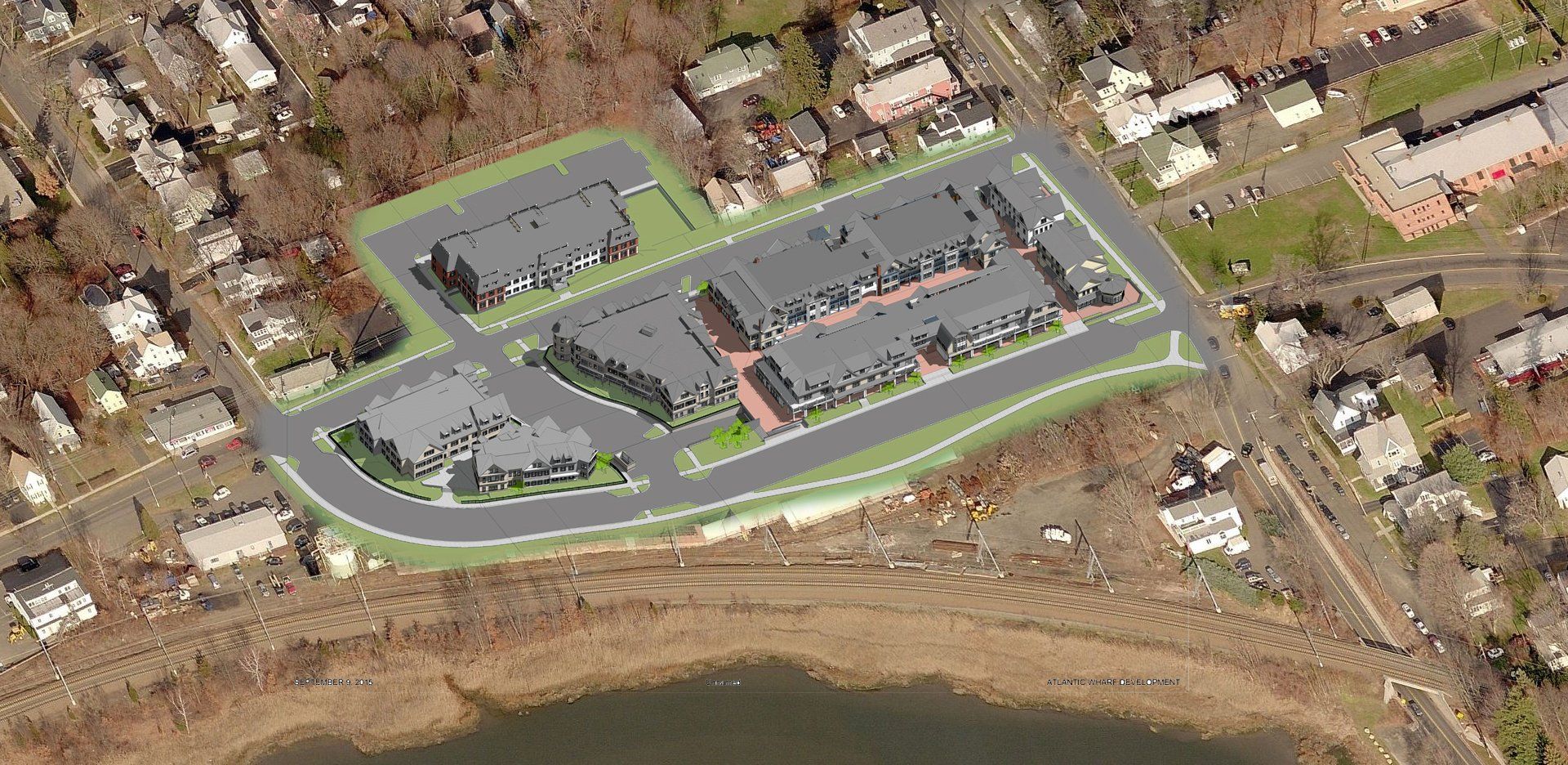 An aerial view of a residential area with a lake in the background.