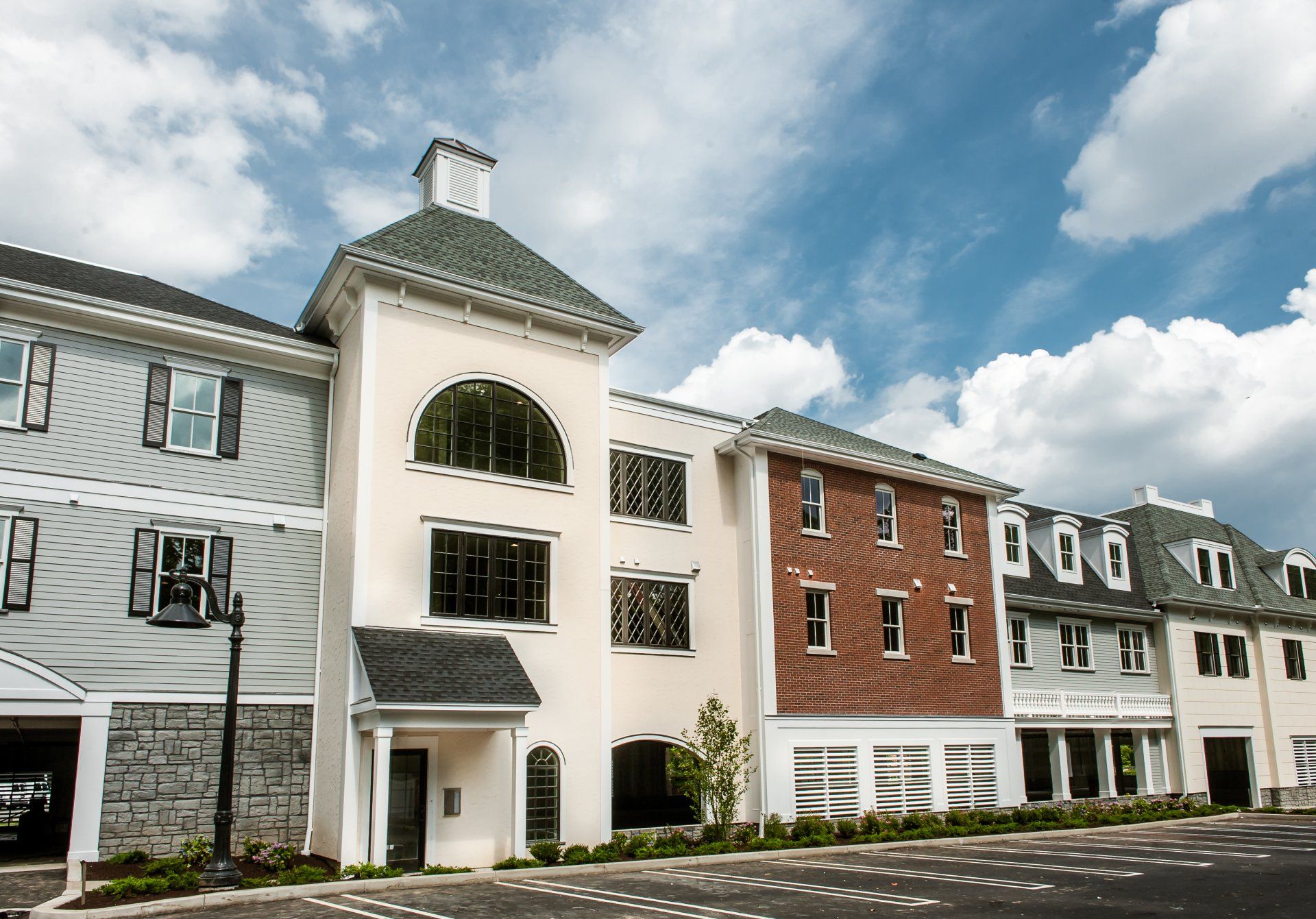 A row of apartment buildings with a green roof
