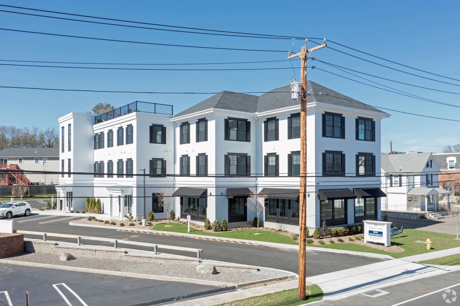 A large white building with a telephone pole in front of it.