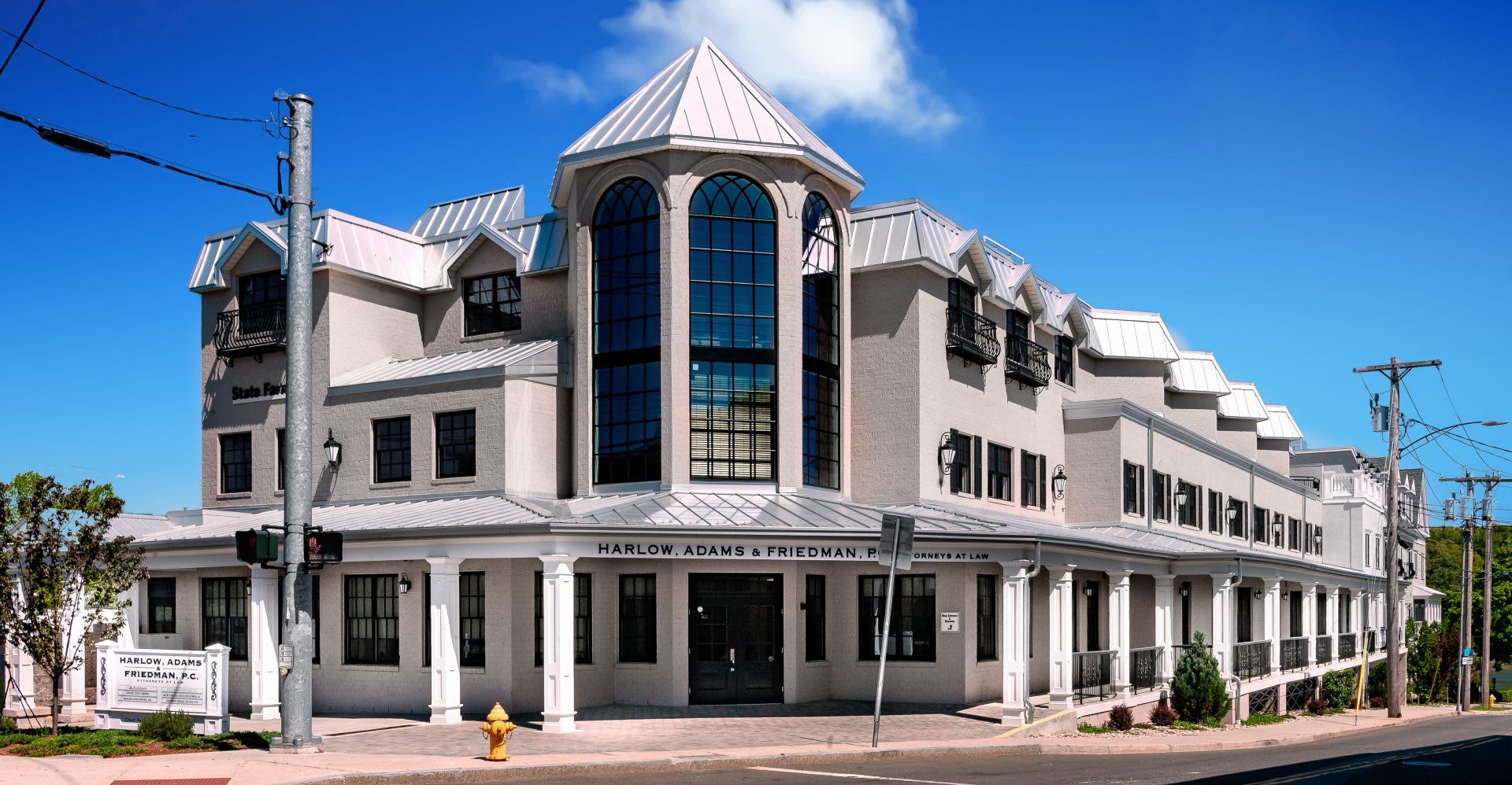 A large white building with a fire hydrant in front of it
