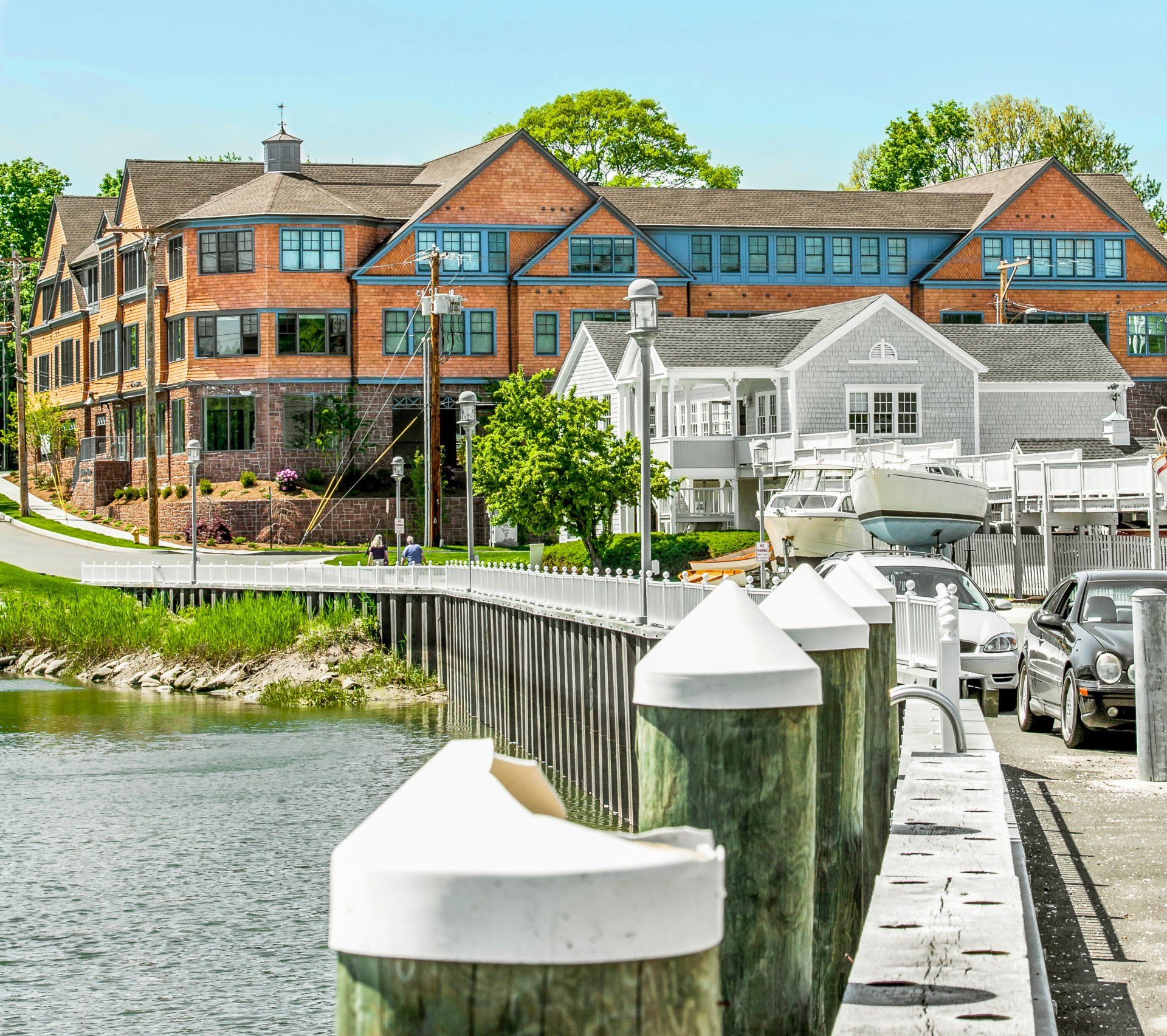 A dock with a large brick building in the background
