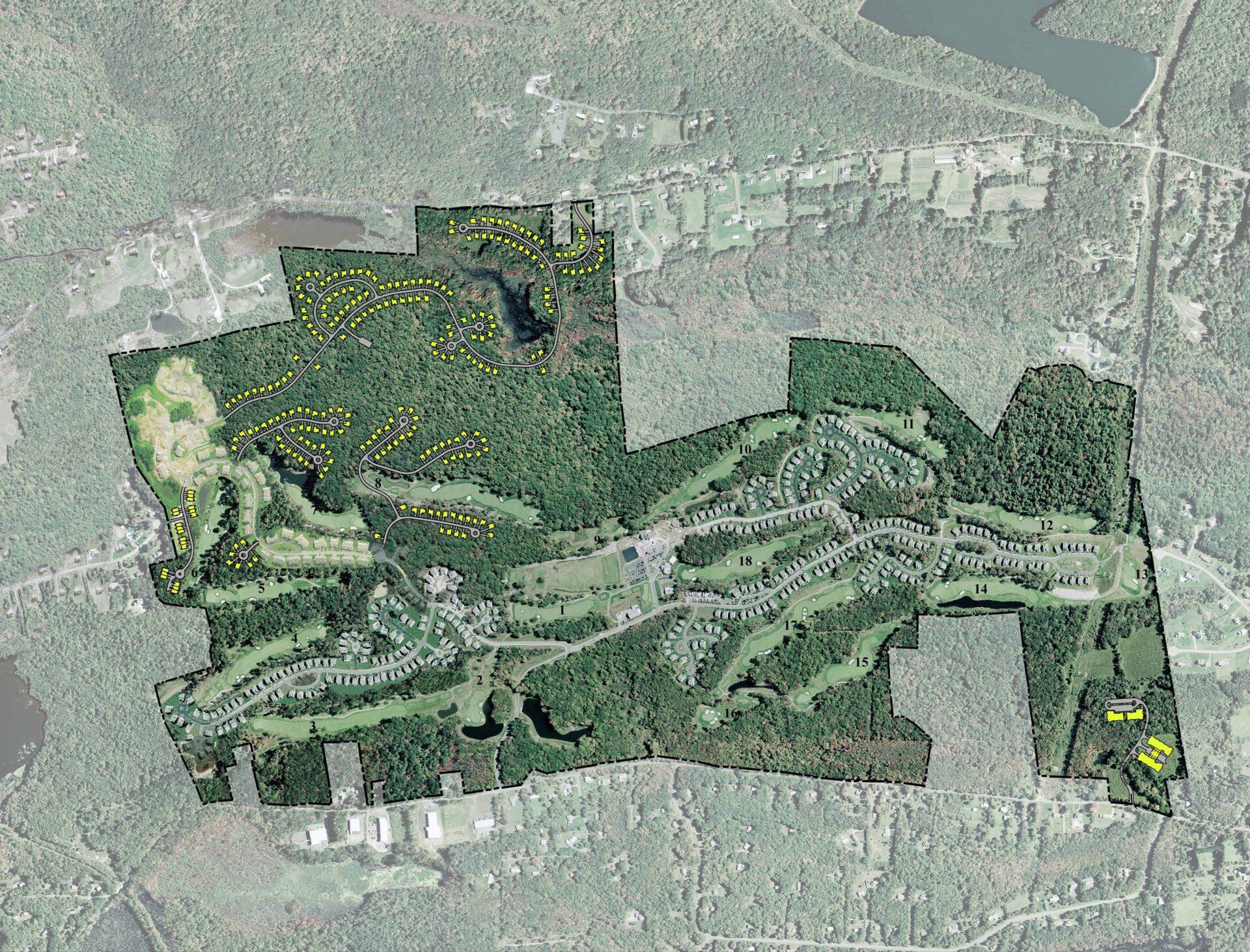 An aerial view of a golf course surrounded by trees.