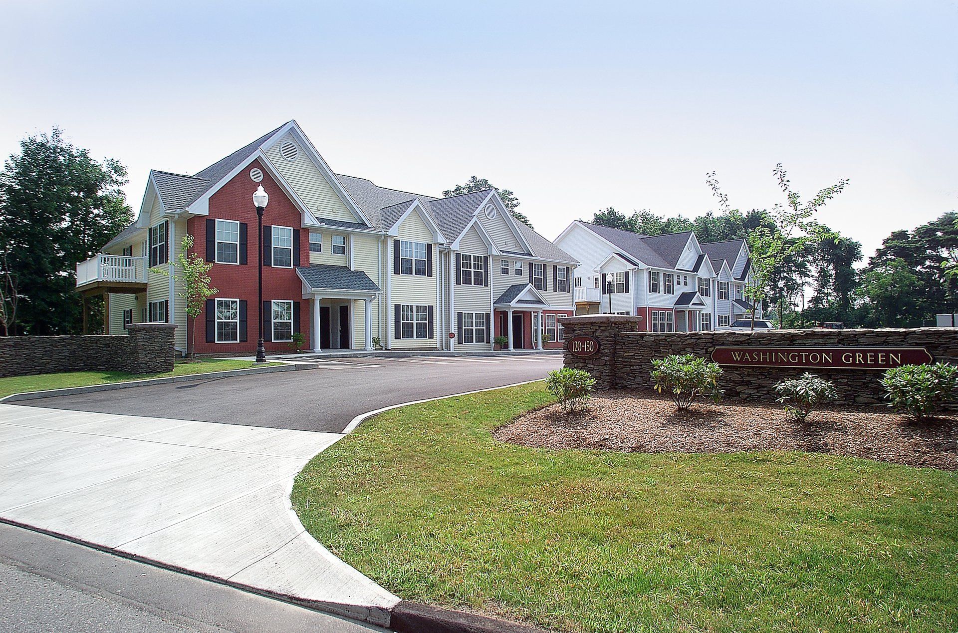 A row of houses with a sign in front of them that says ' cherry grove '