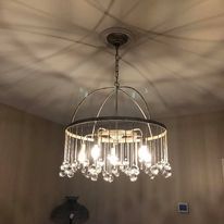 A chandelier is hanging from the ceiling in a room.
