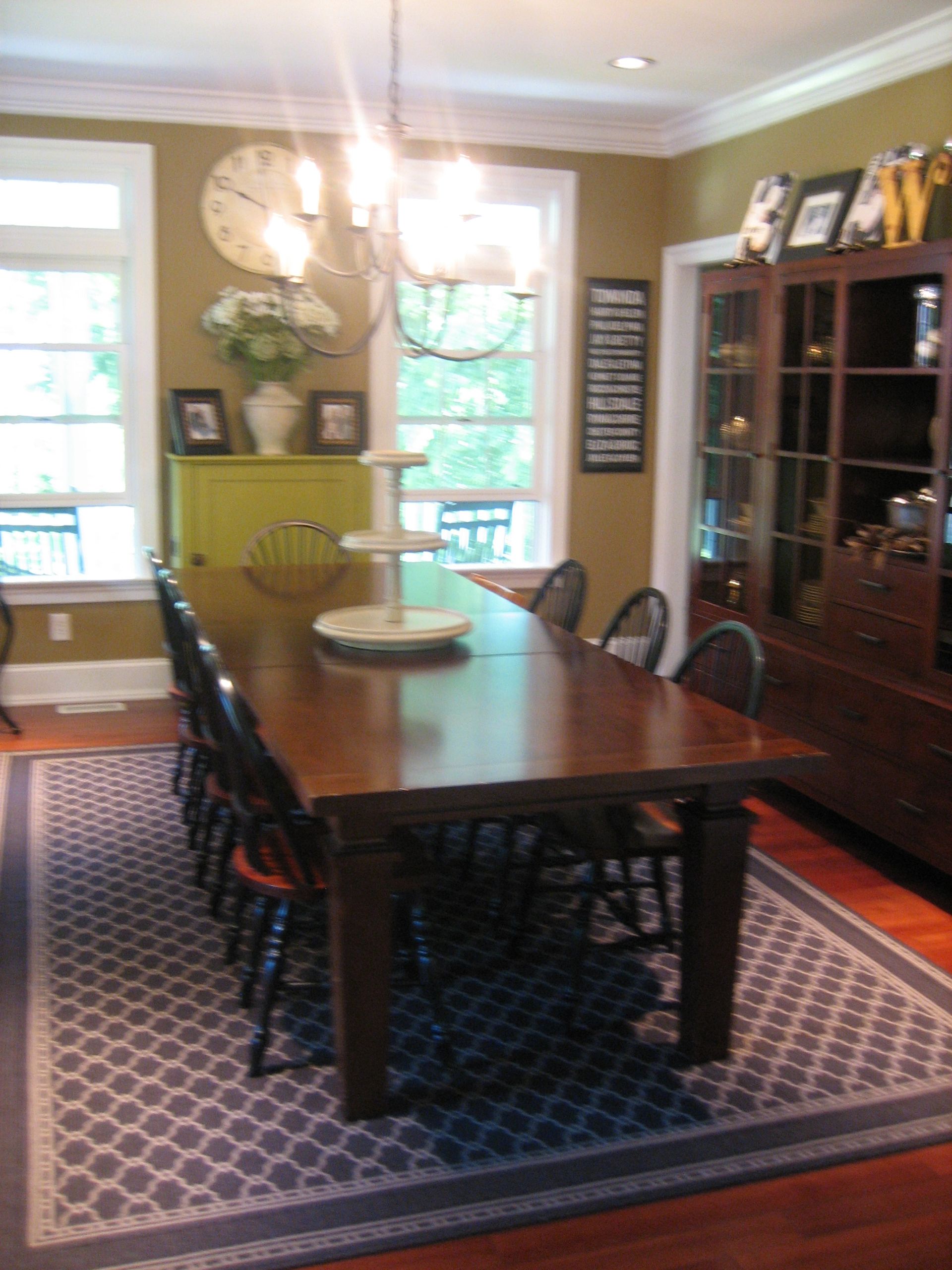 A dining room with a long table and chairs