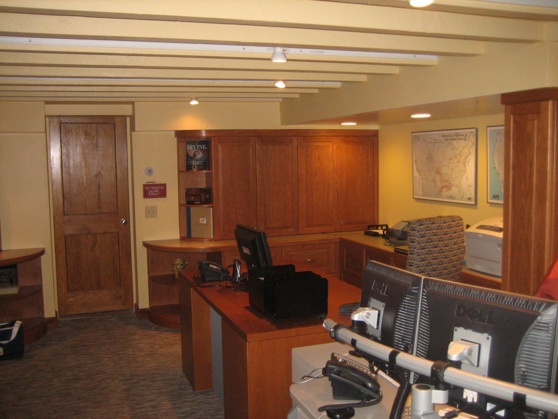 A room with two computer monitors on a desk