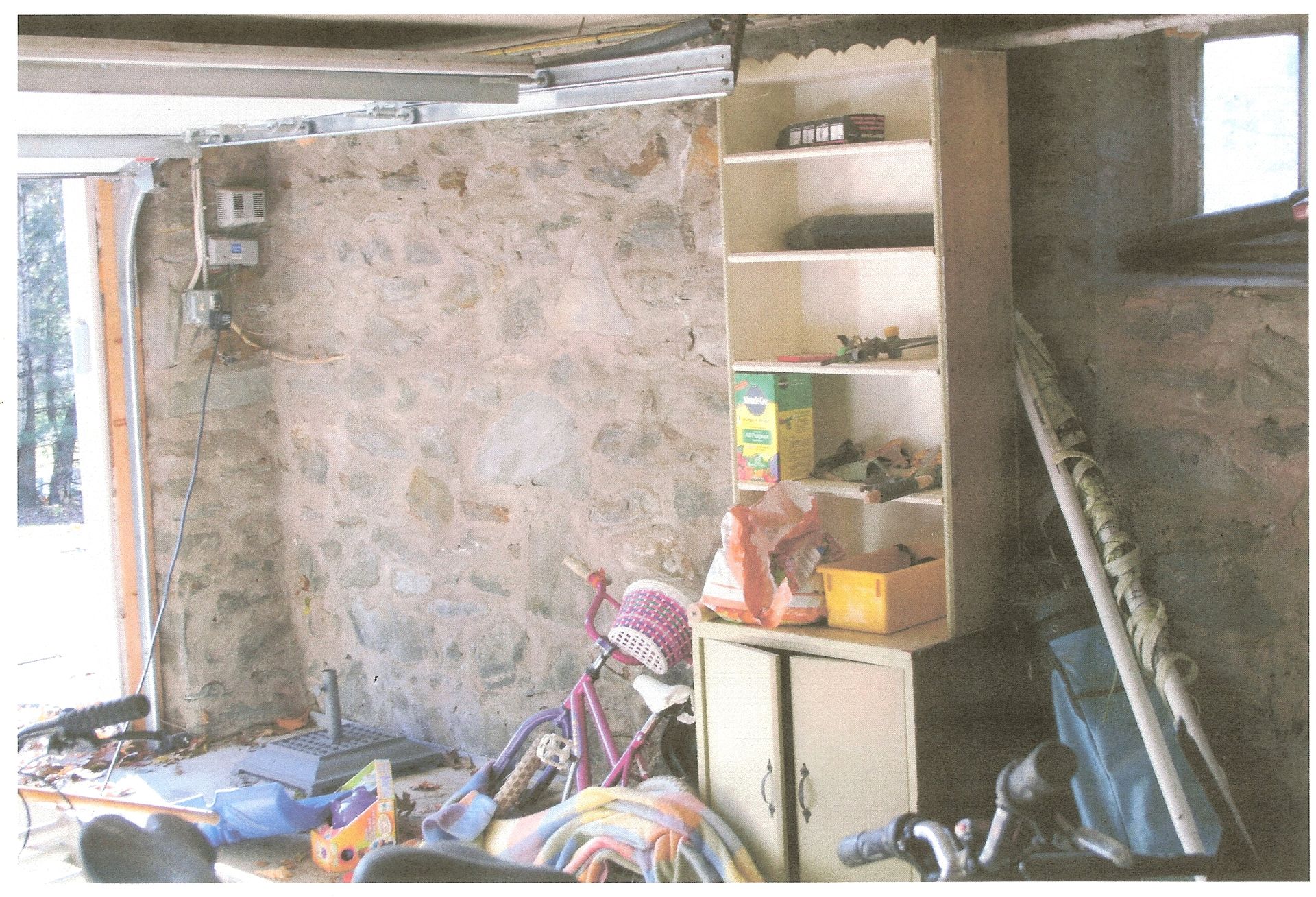 A room with a shelf and a bicycle in it