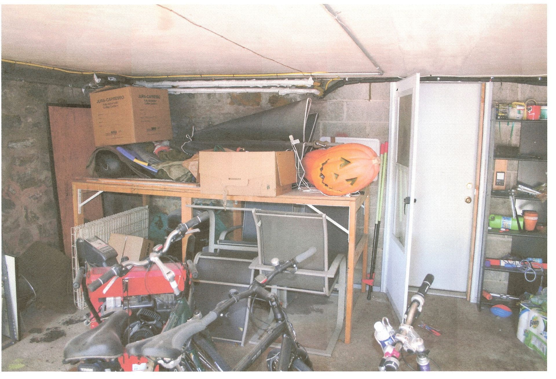 A picture of a garage with a pumpkin on a table