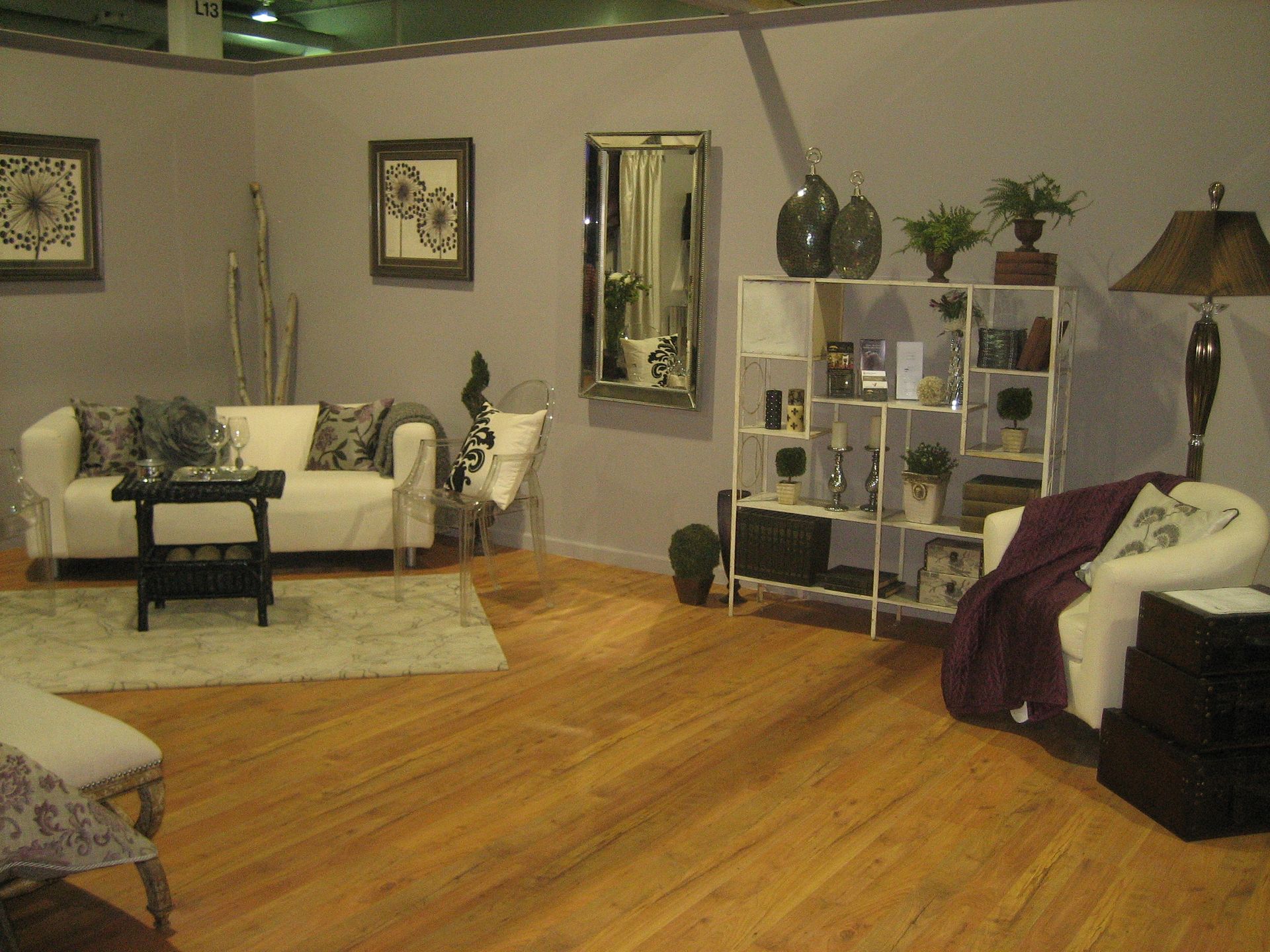 A living room with a couch a chair and a lamp