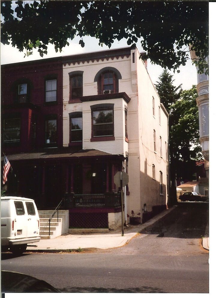 A white van is parked in front of a building