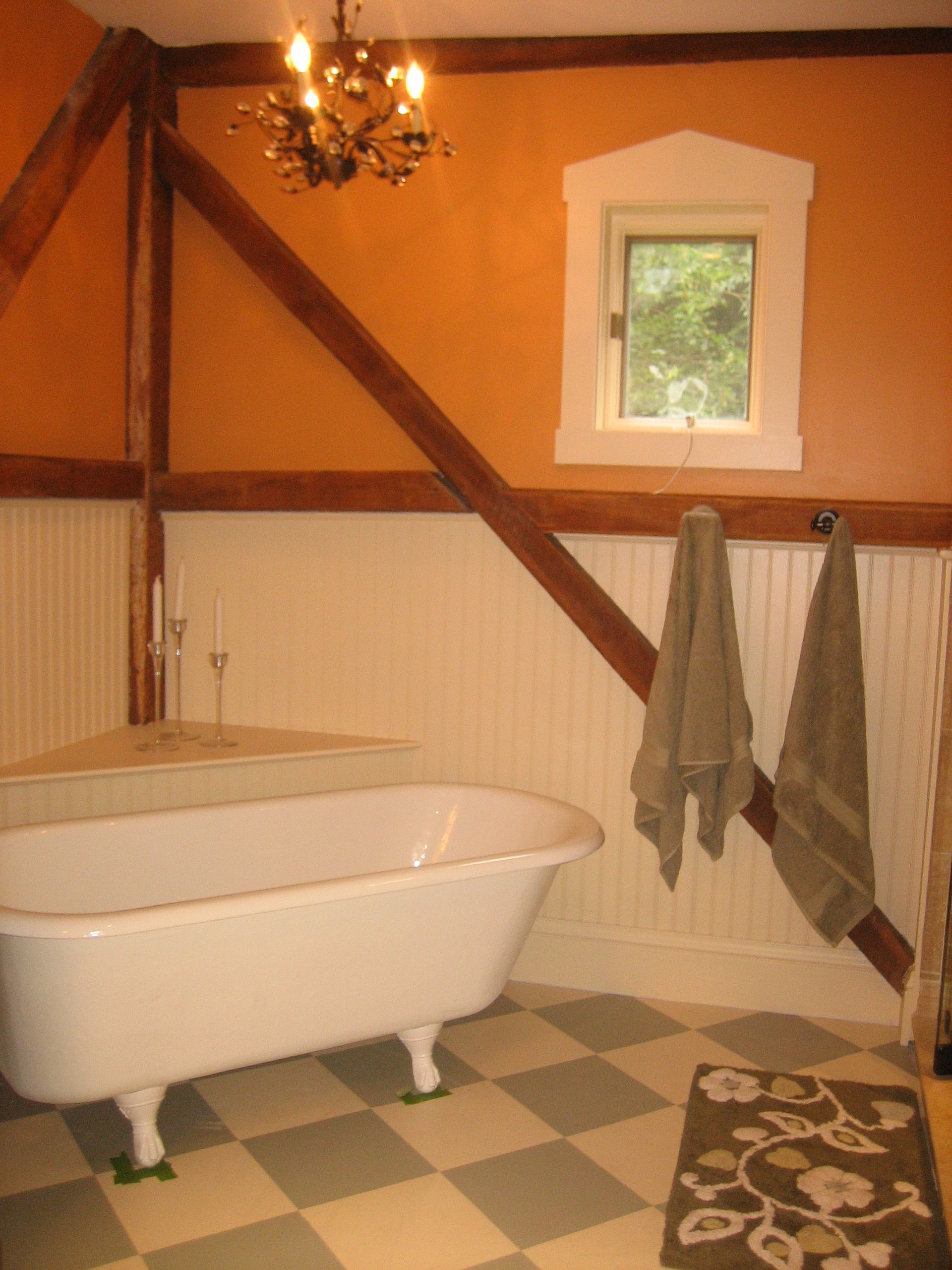 A bathroom with a claw foot tub and a window