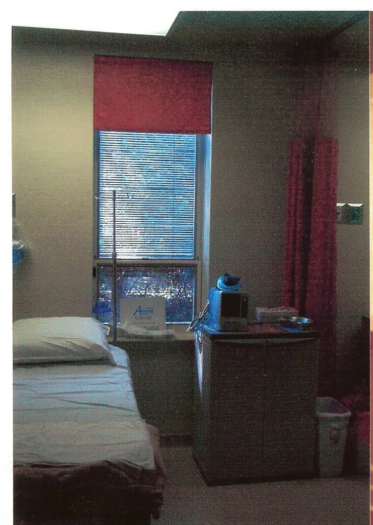 A hospital room with a bed and a window