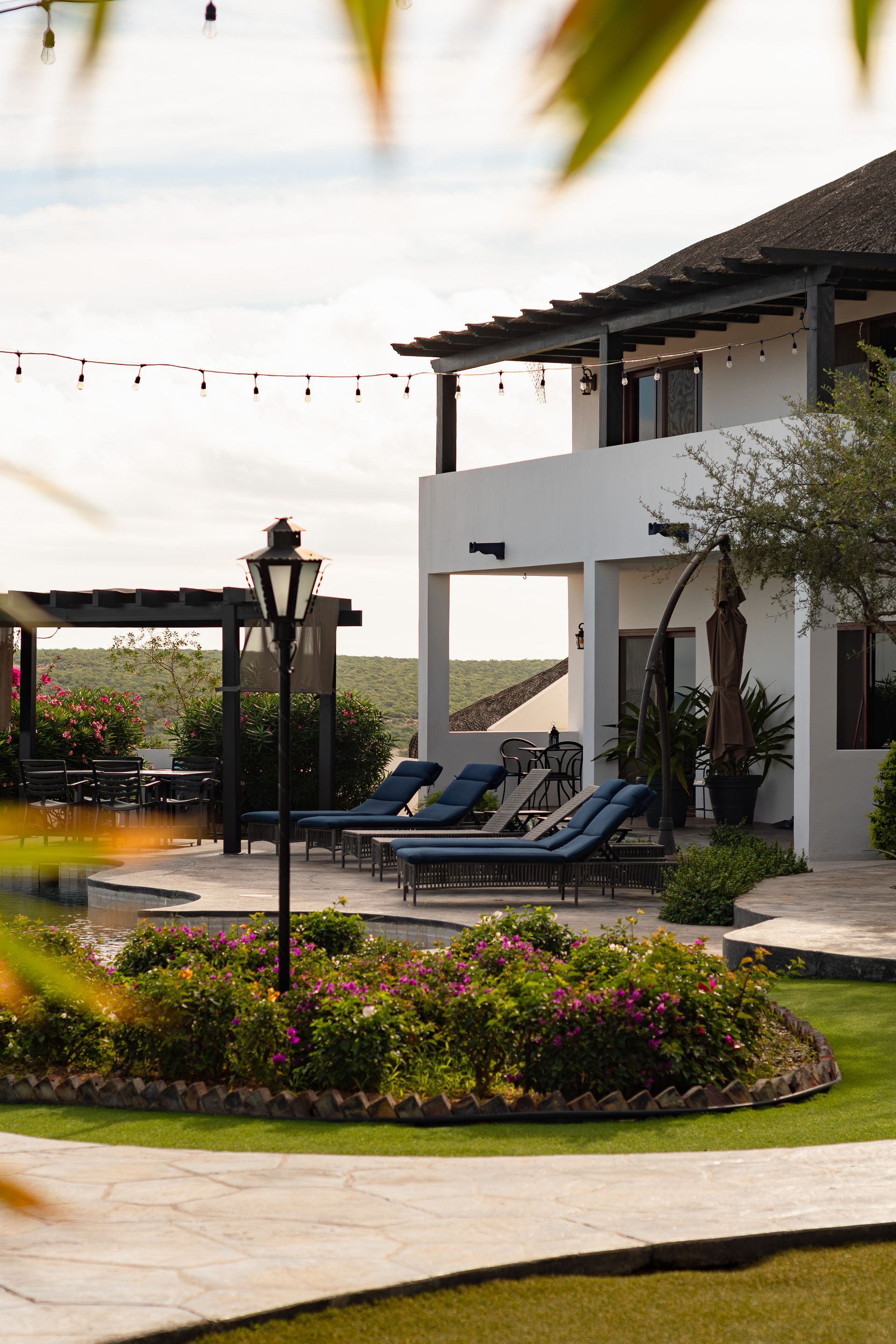 A large white house with a lot of lawn chairs in front of it