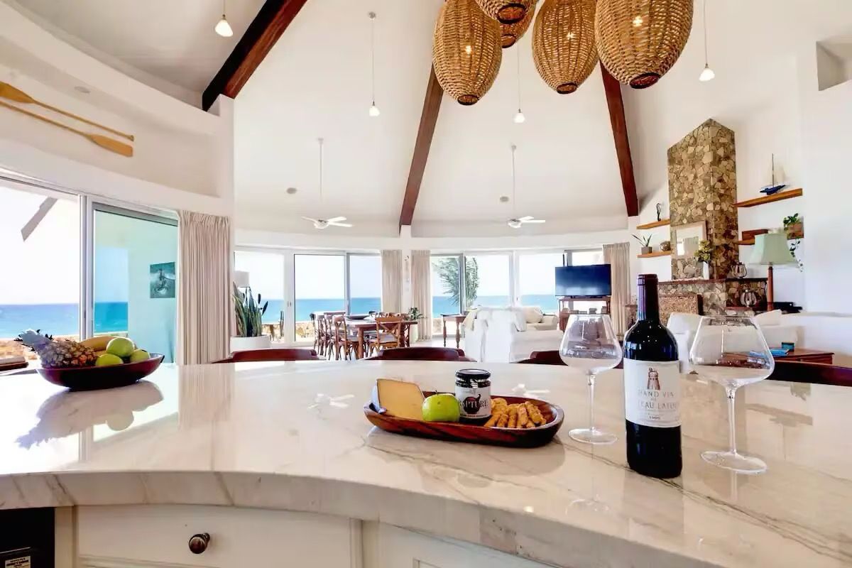 A bottle of wine is sitting on a counter in a kitchen.