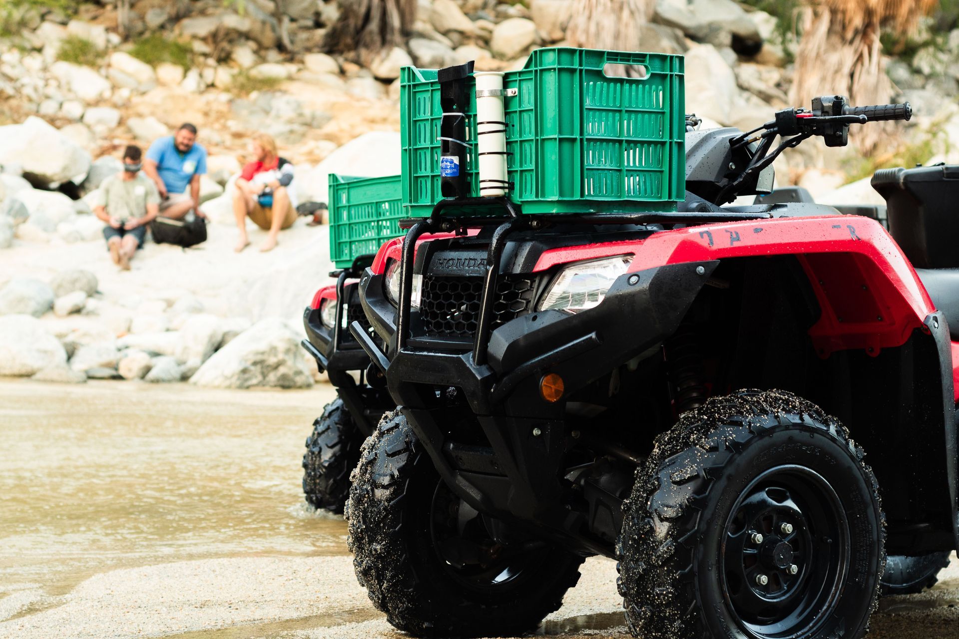 A red atv with a green crate on top of it