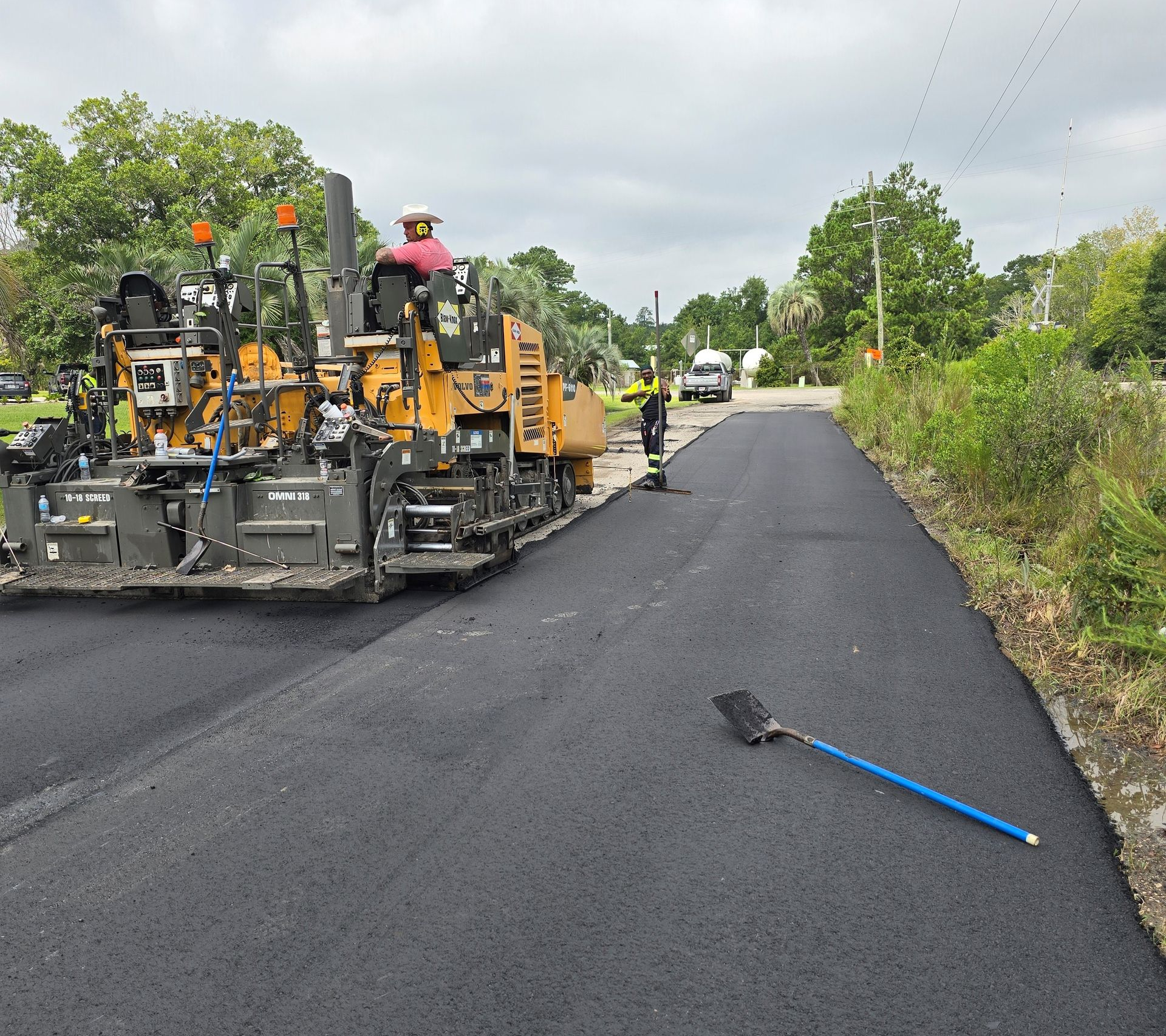 Man Standing On Road With Asphalt Paving — Jacksonville, FL — Pro Sealed Asphalt Inc.