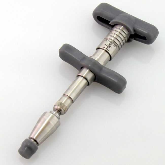 The Activator instrument used in gentle, crack-free chiropractic adjustments