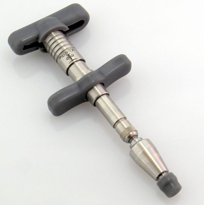 The Activator Instrument, used in making gentle, no-crack Chiropractic adjustments