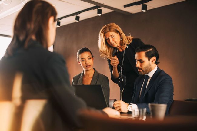 A group of business people are having a meeting in a conference room.