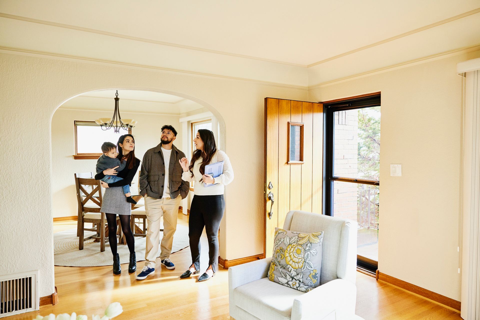 A family is looking at a house with a real estate agent.