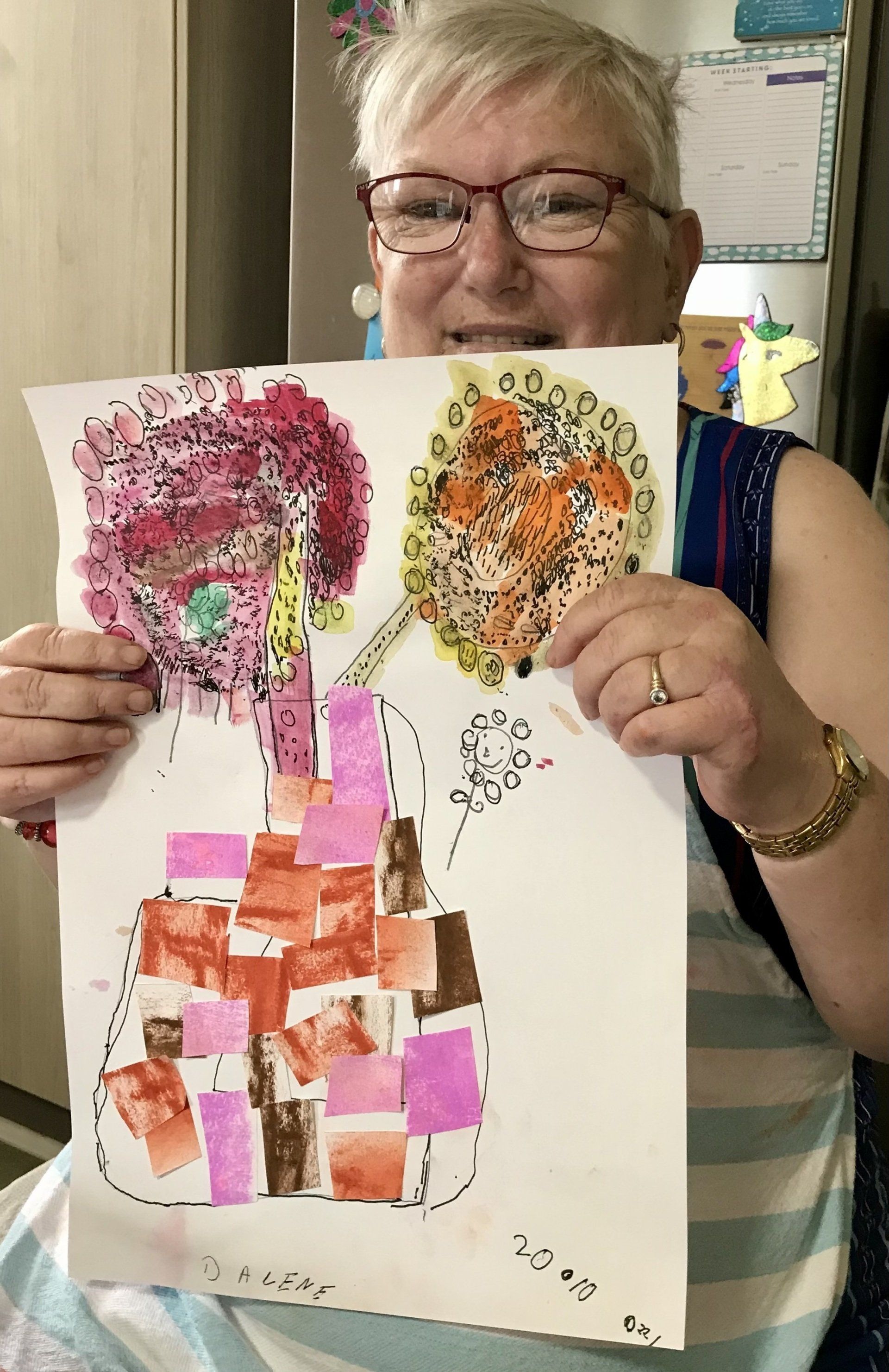Darlene and her artwork of sunflowers in vase