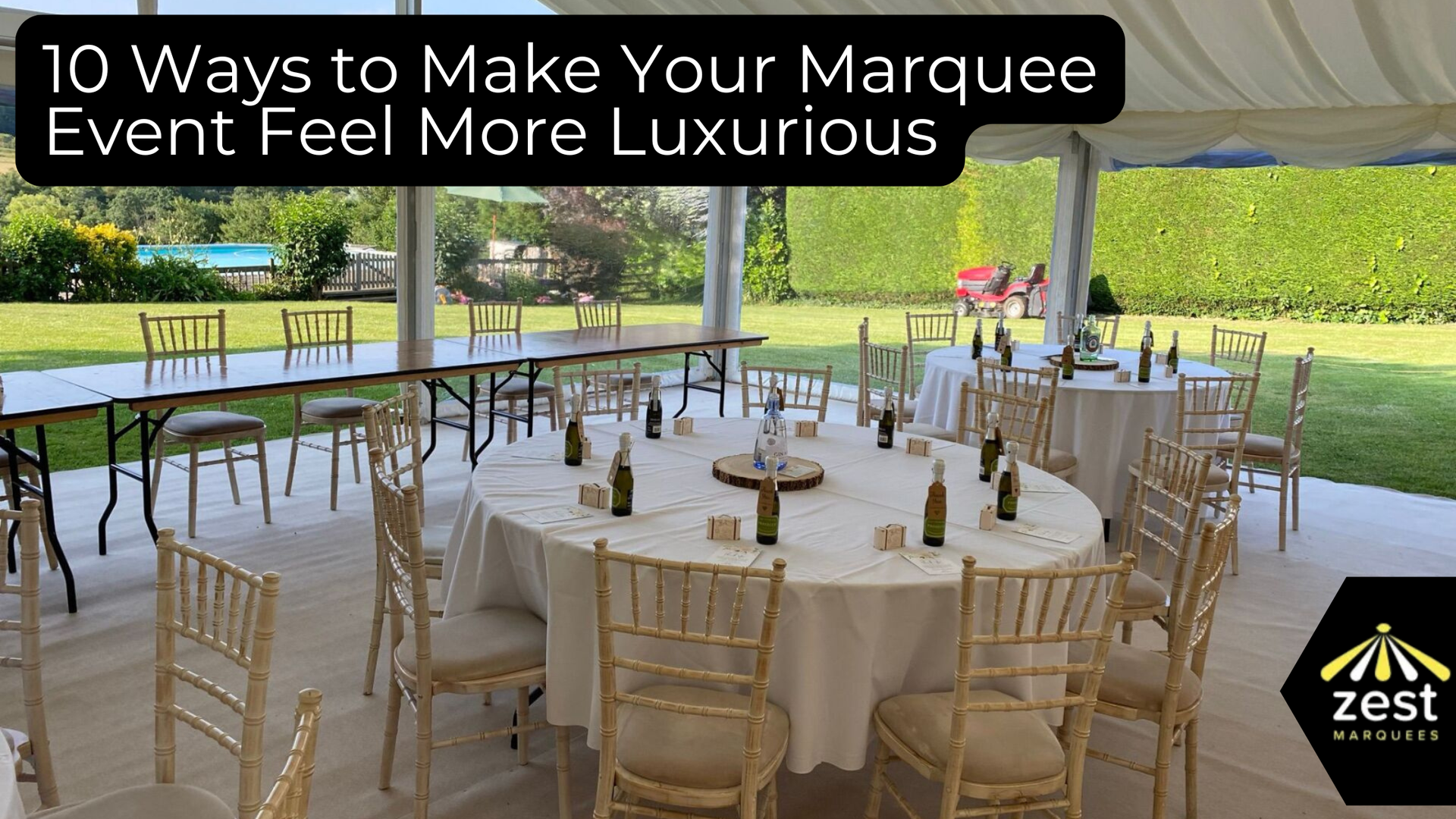 Elegant white event tent with gold chairs and round tables set for a luxury outdoor marquee reception