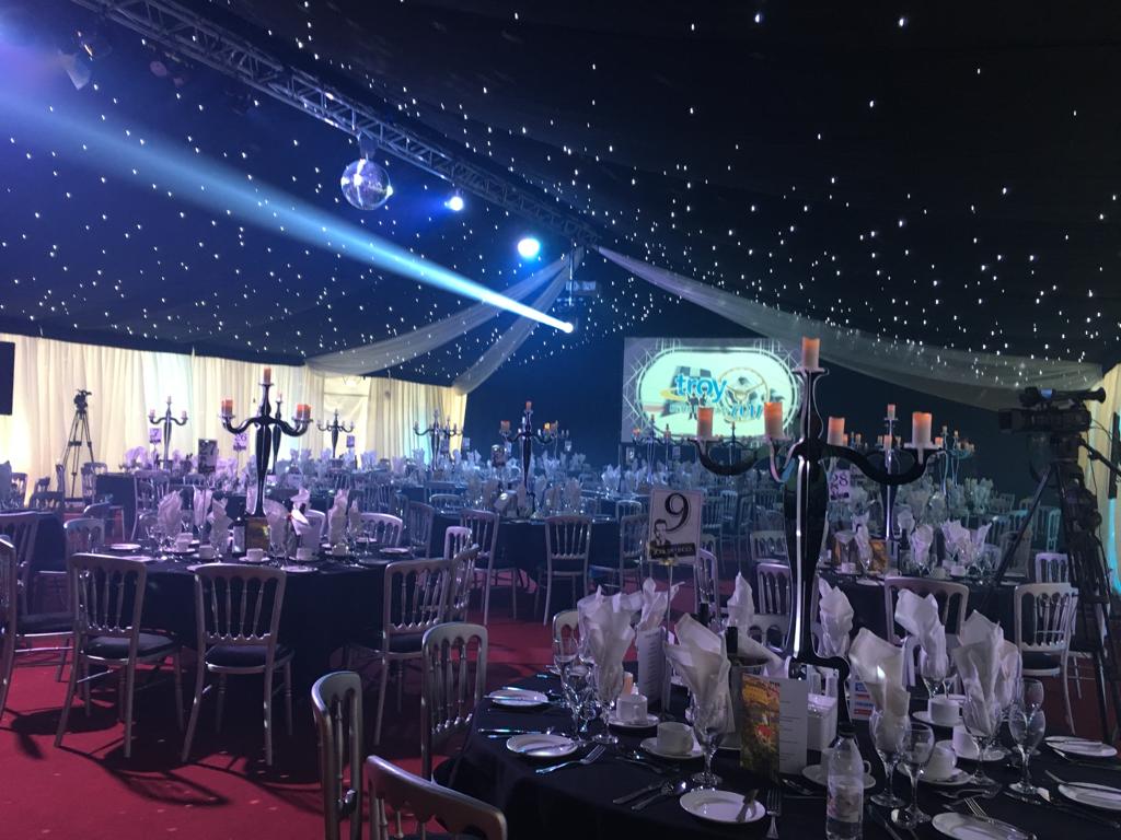 A large room with tables and chairs set up for a banquet.