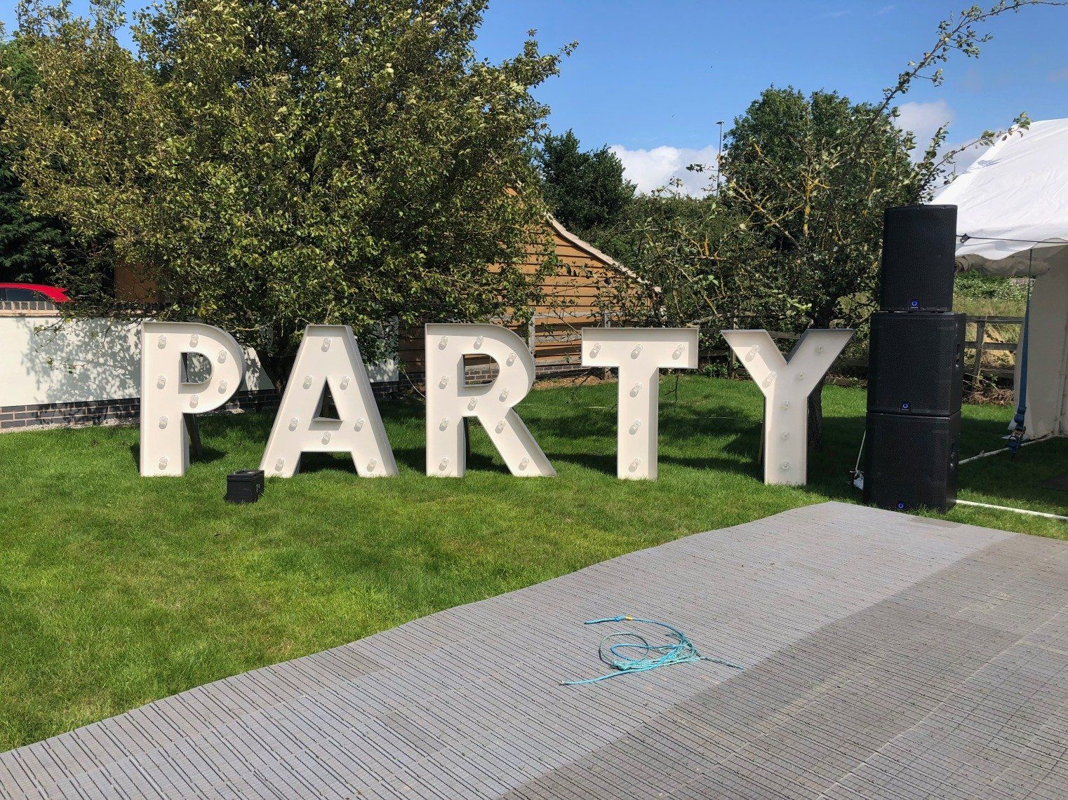 The word party is written in large letters on the grass.