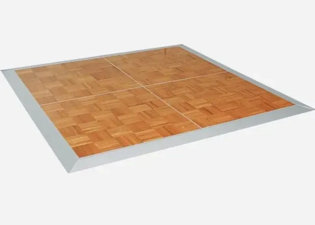A wooden dance floor with a white border on a white background.