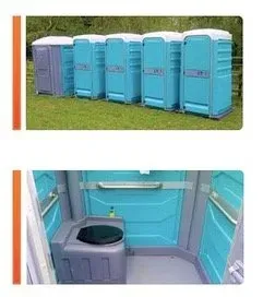 A row of portable toilets sitting on top of a lush green field.