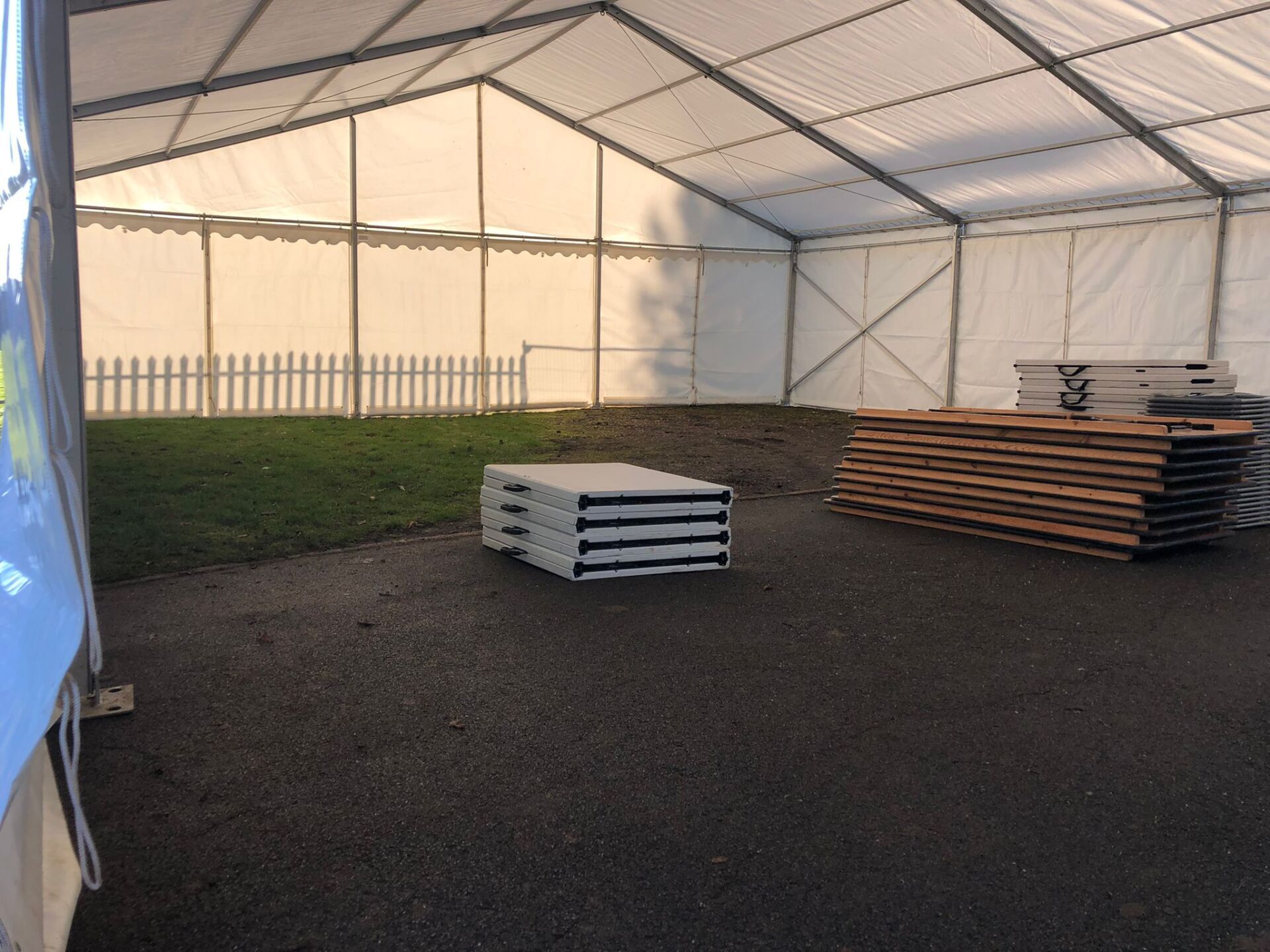 A large white tent with a lot of wood inside of it