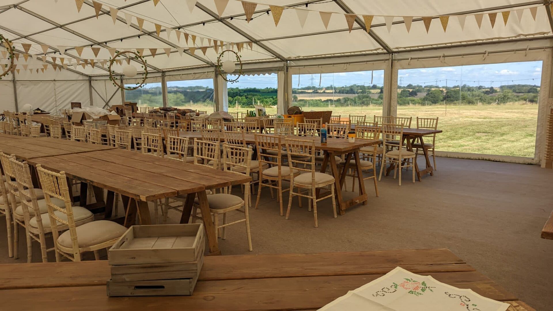 A large tent with tables and chairs inside of it.