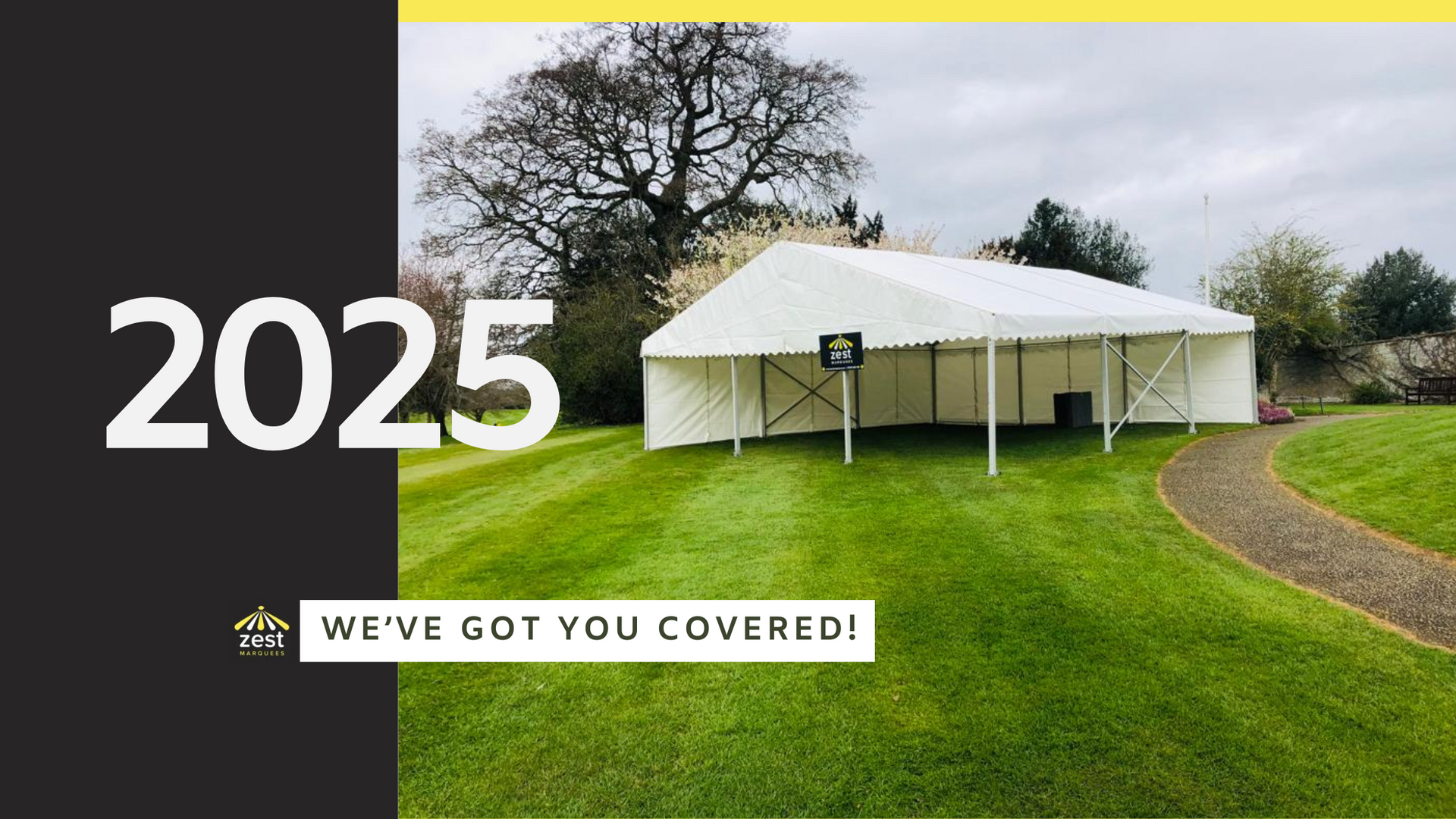 A large white tent is sitting in the middle of a lush green field.