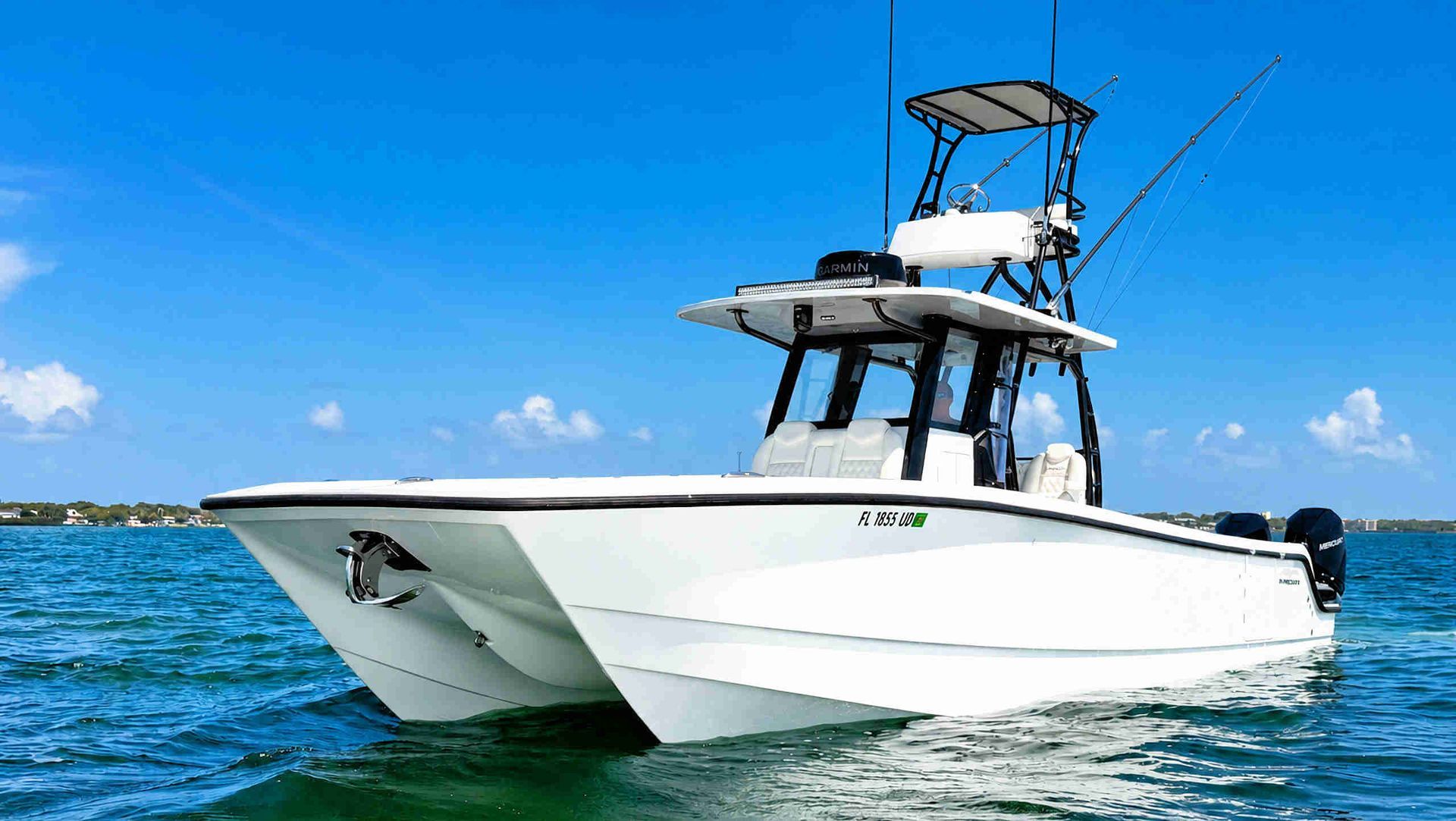 White catamaran center console fishing boat on blue ocean under a clear sky